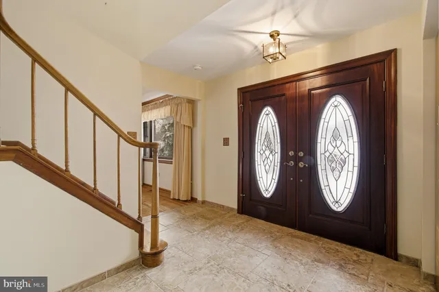 a bathroom with a granite countertop sink and a toilet