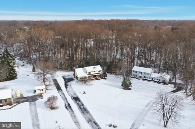 a view of a house with a yard covered with snow in the yard