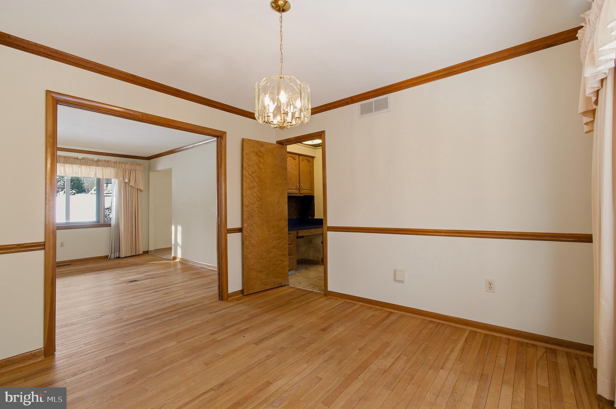 1290 Whirl A Way Court Gambrills, MD 21054 - Photo 29 of 111 a view of a hallway with wooden floor and chandelier