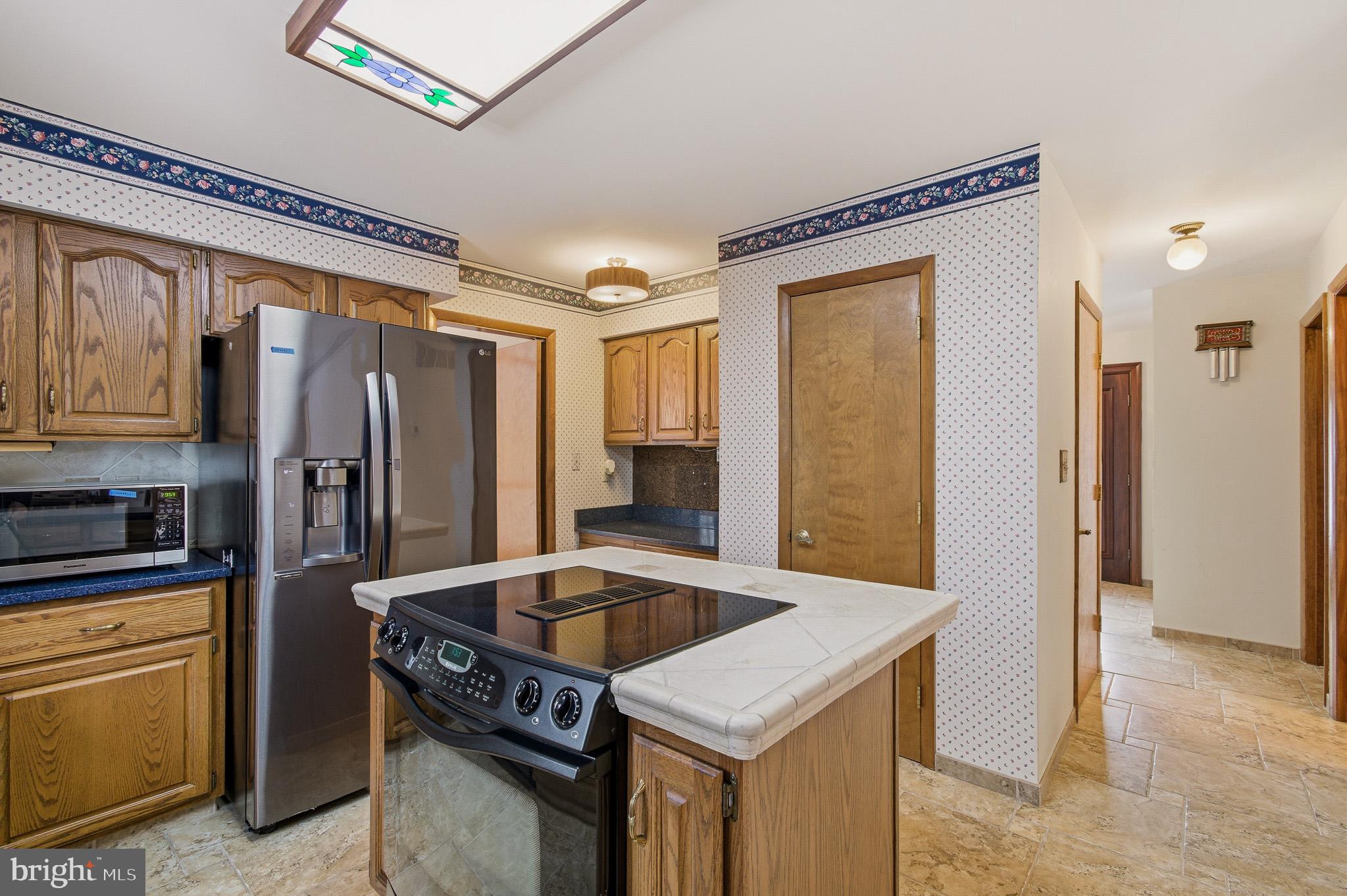 1290 Whirl A Way Court Gambrills, MD 21054 - Photo 39 of 111 a kitchen with a refrigerator a sink and cabinets