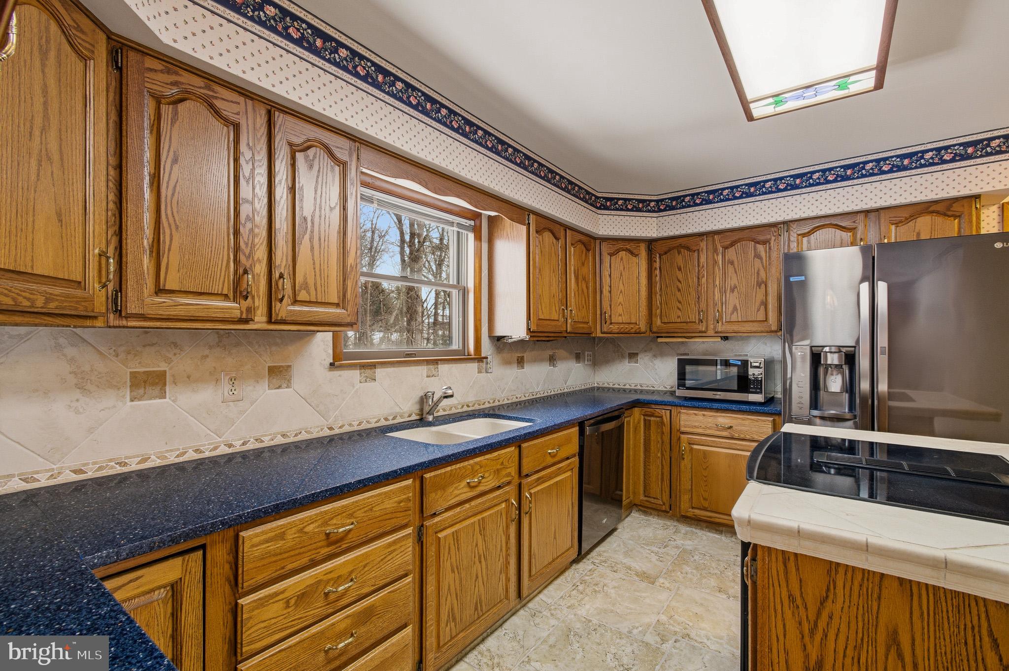 1290 Whirl A Way Court Gambrills, MD 21054 - Photo 41 of 111 a kitchen with stainless steel appliances granite countertop a sink refrigerator stove and microwave
