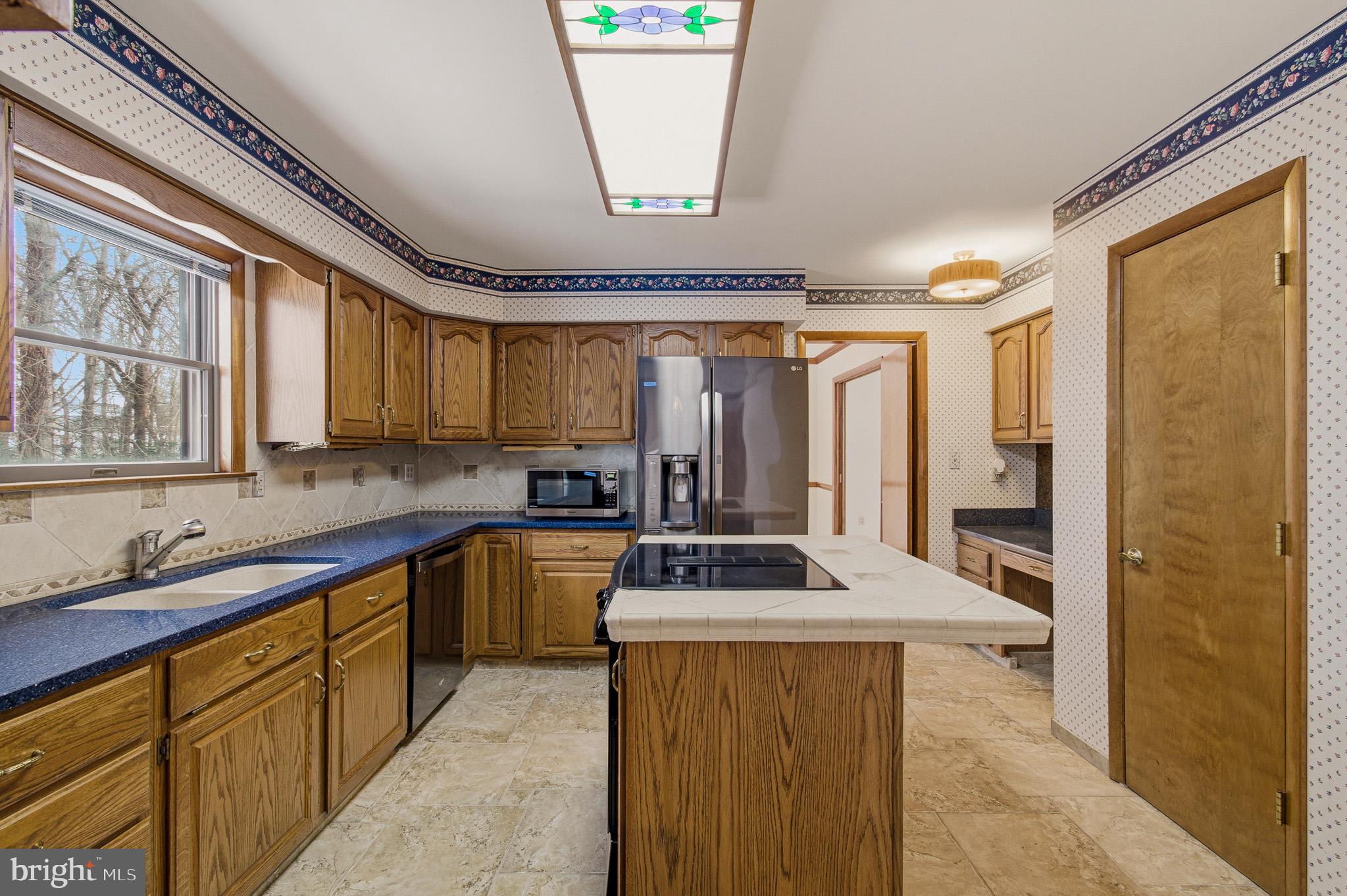 1290 Whirl A Way Court Gambrills, MD 21054 - Photo 42 of 111 a kitchen with stainless steel appliances a stove a sink and a refrigerator