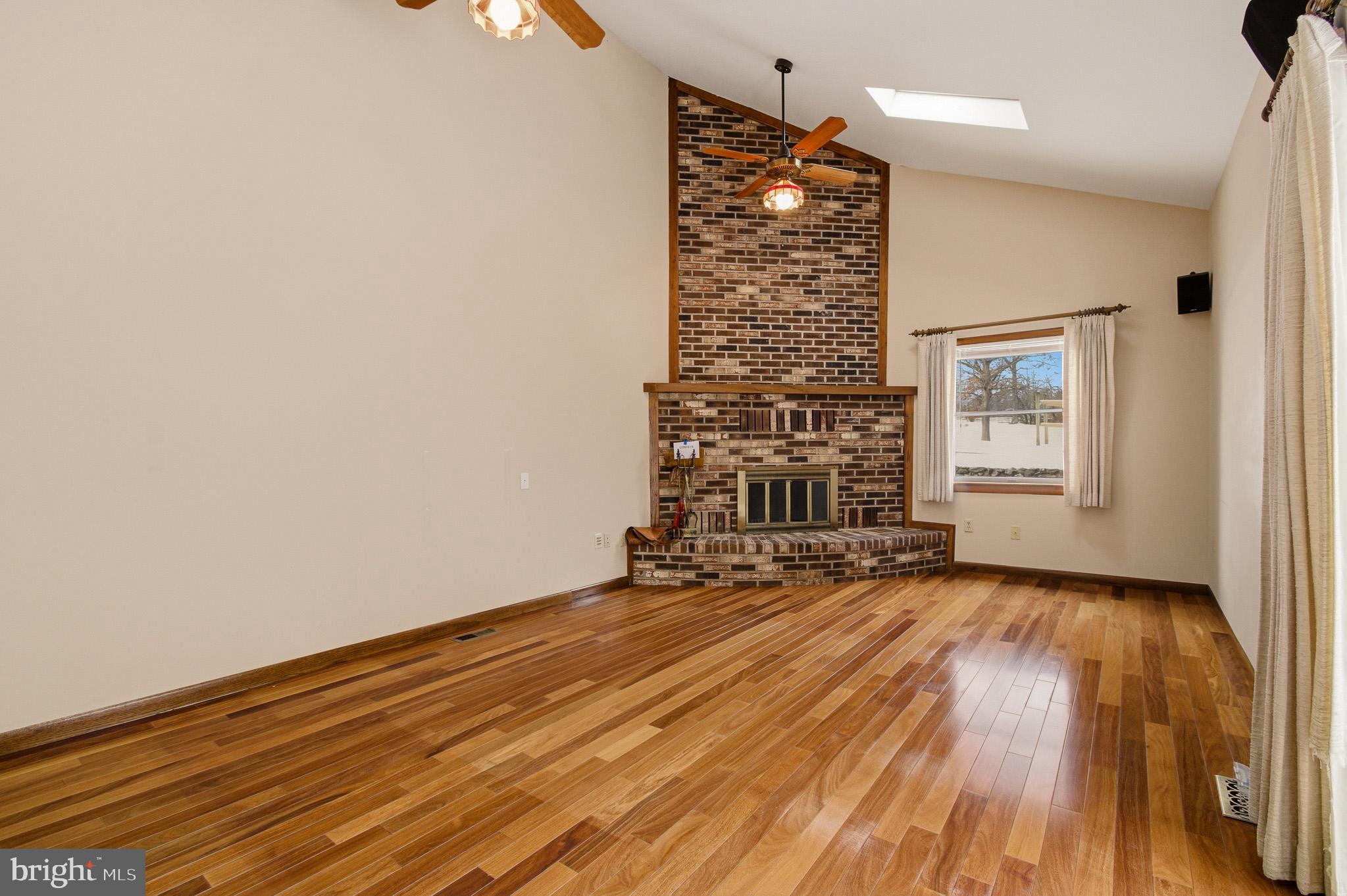 1290 Whirl A Way Court Gambrills, MD 21054 - Photo 51 of 111 a view of an empty room with a window and wooden floor