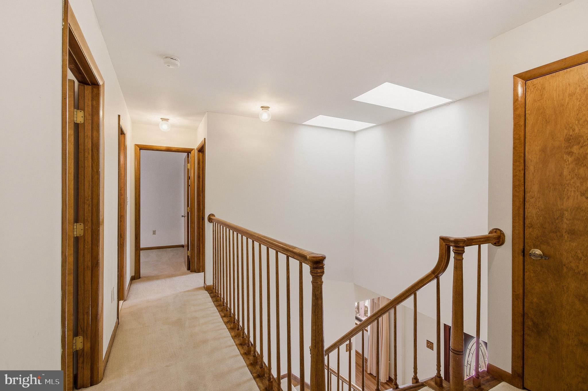 1290 Whirl A Way Court Gambrills, MD 21054 - Photo 63 of 111 a view of a hallway with wooden floor and staircase