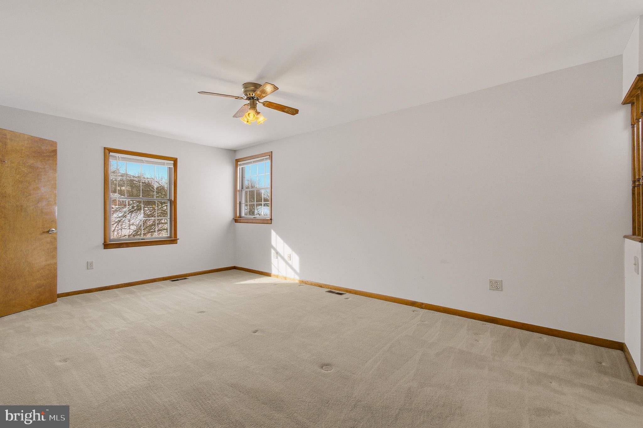 1290 Whirl A Way Court Gambrills, MD 21054 - Photo 65 of 111 an empty room with windows and ceiling fan view