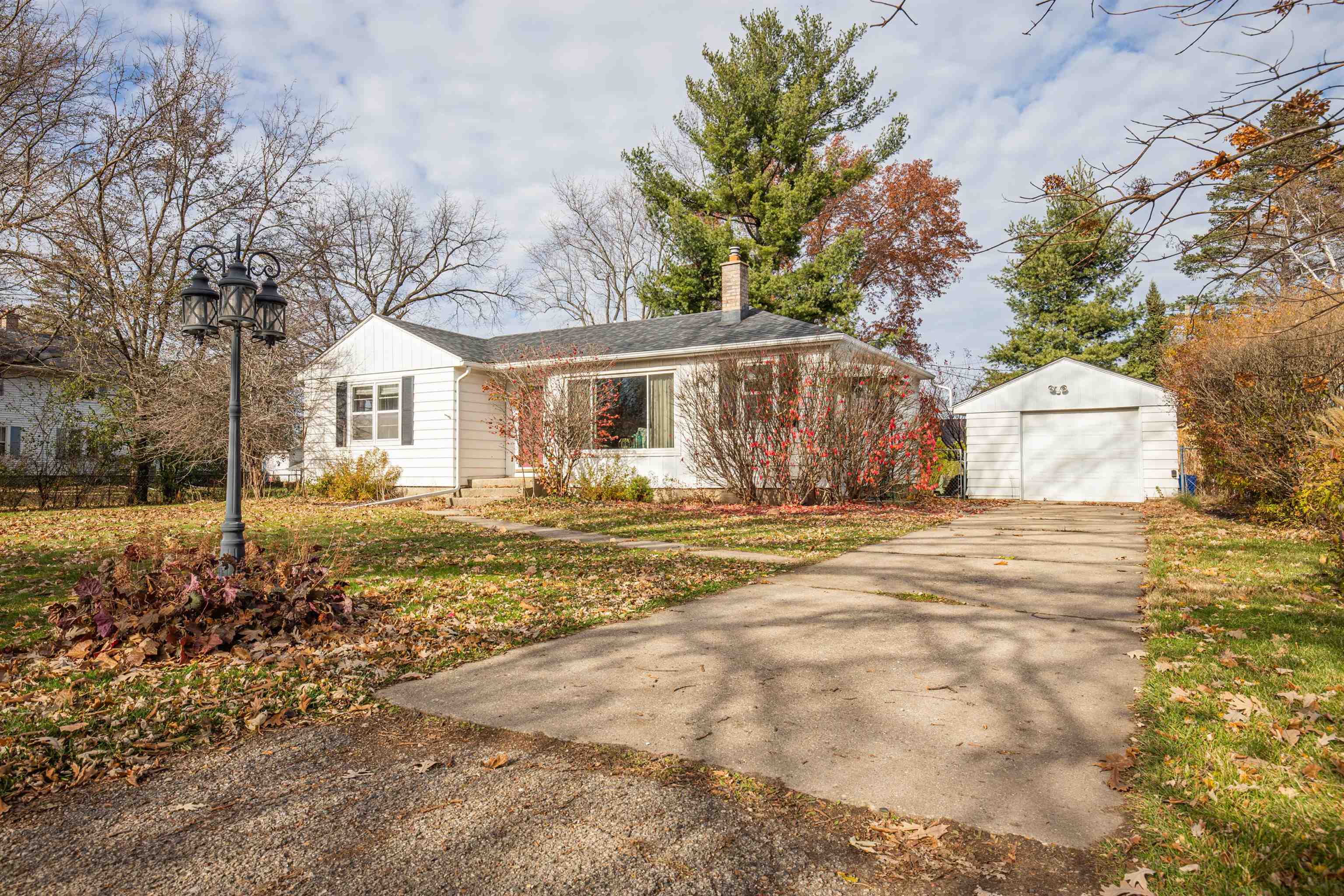 3808 Highcrest Road Rockford, IL 61107 - Photo 1 of 34 a front view of a house with a yard and trees