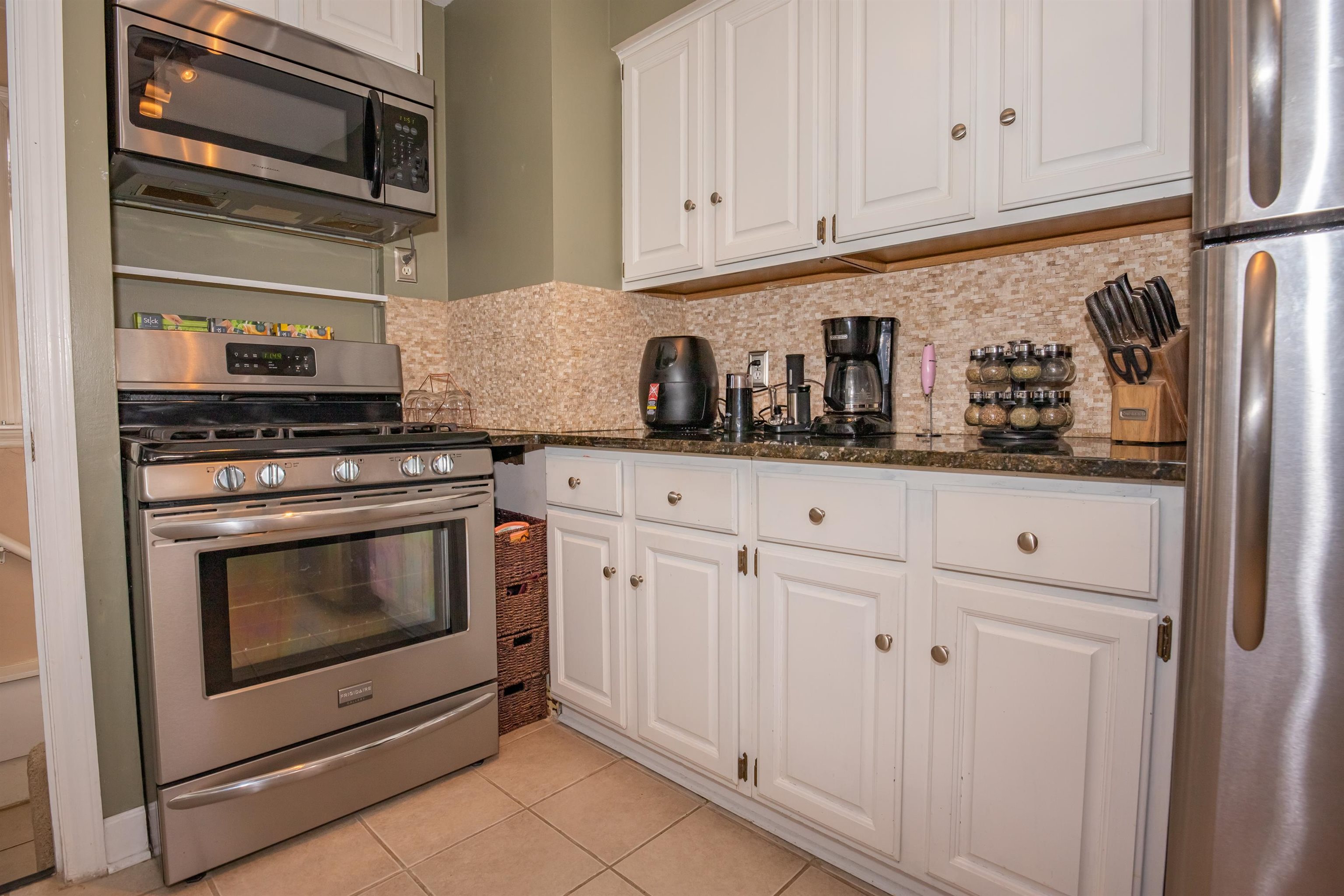 3808 Highcrest Road Rockford, IL 61107 - Photo 12 of 34 a kitchen with granite countertop white cabinets and stainless steel appliances