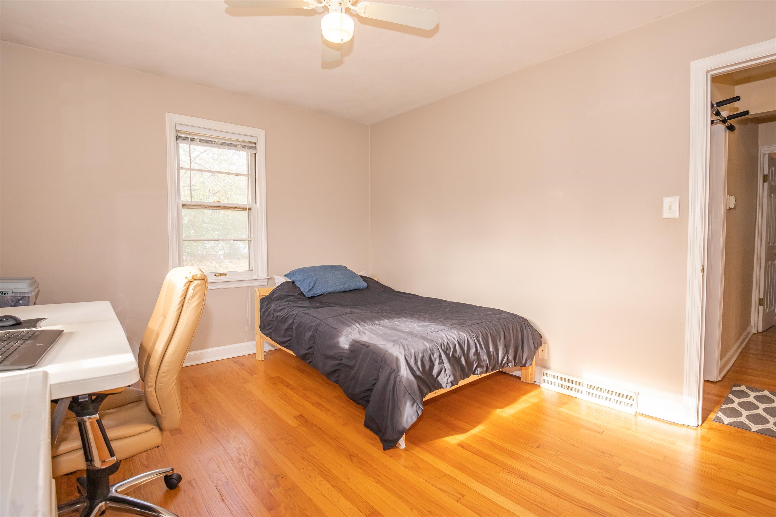 3808 Highcrest Road Rockford, IL 61107 - Photo 17 of 34 a bedroom with a bed and wooden floor