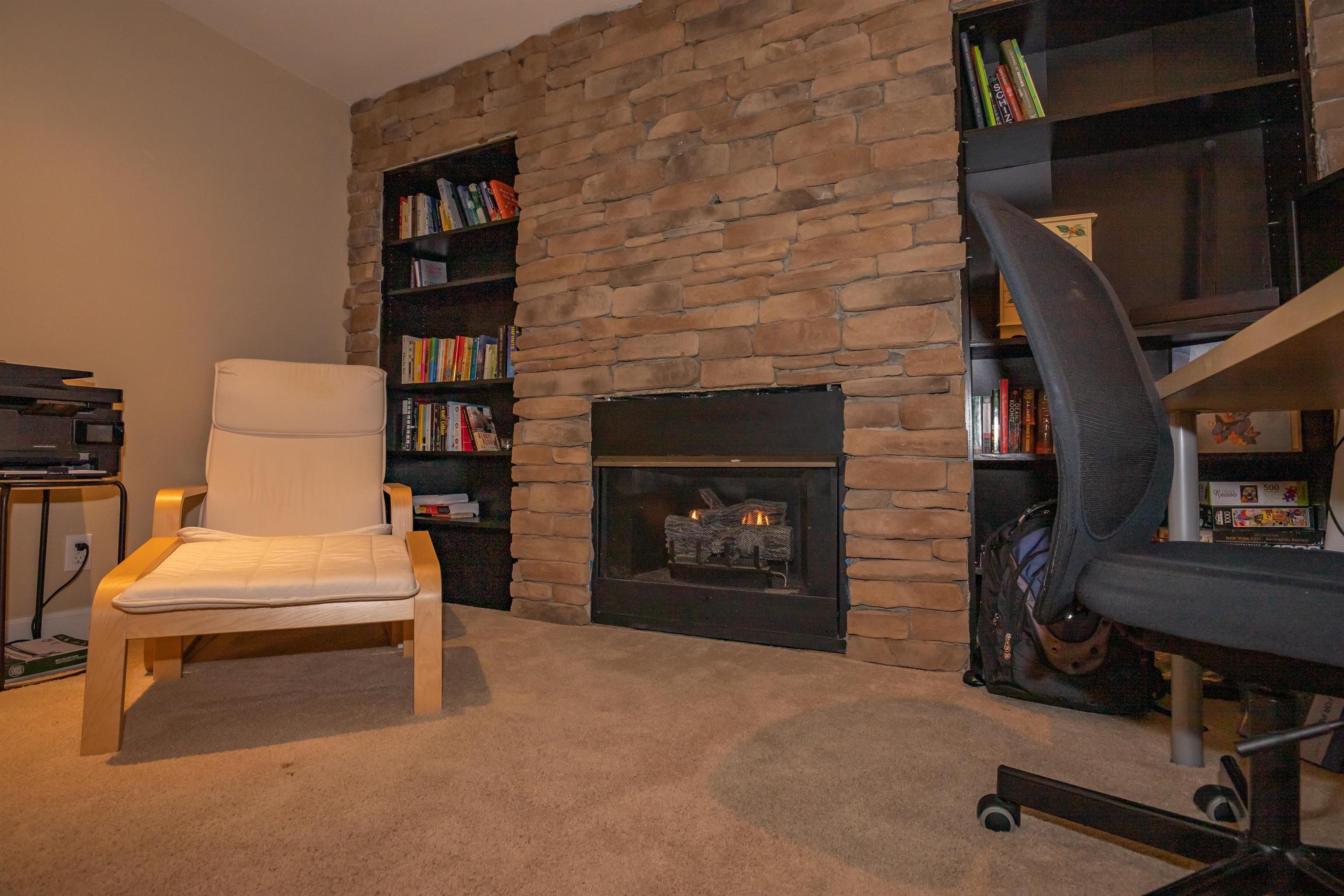 3808 Highcrest Road Rockford, IL 61107 - Photo 26 of 34 a bedroom with a bed and a fireplace