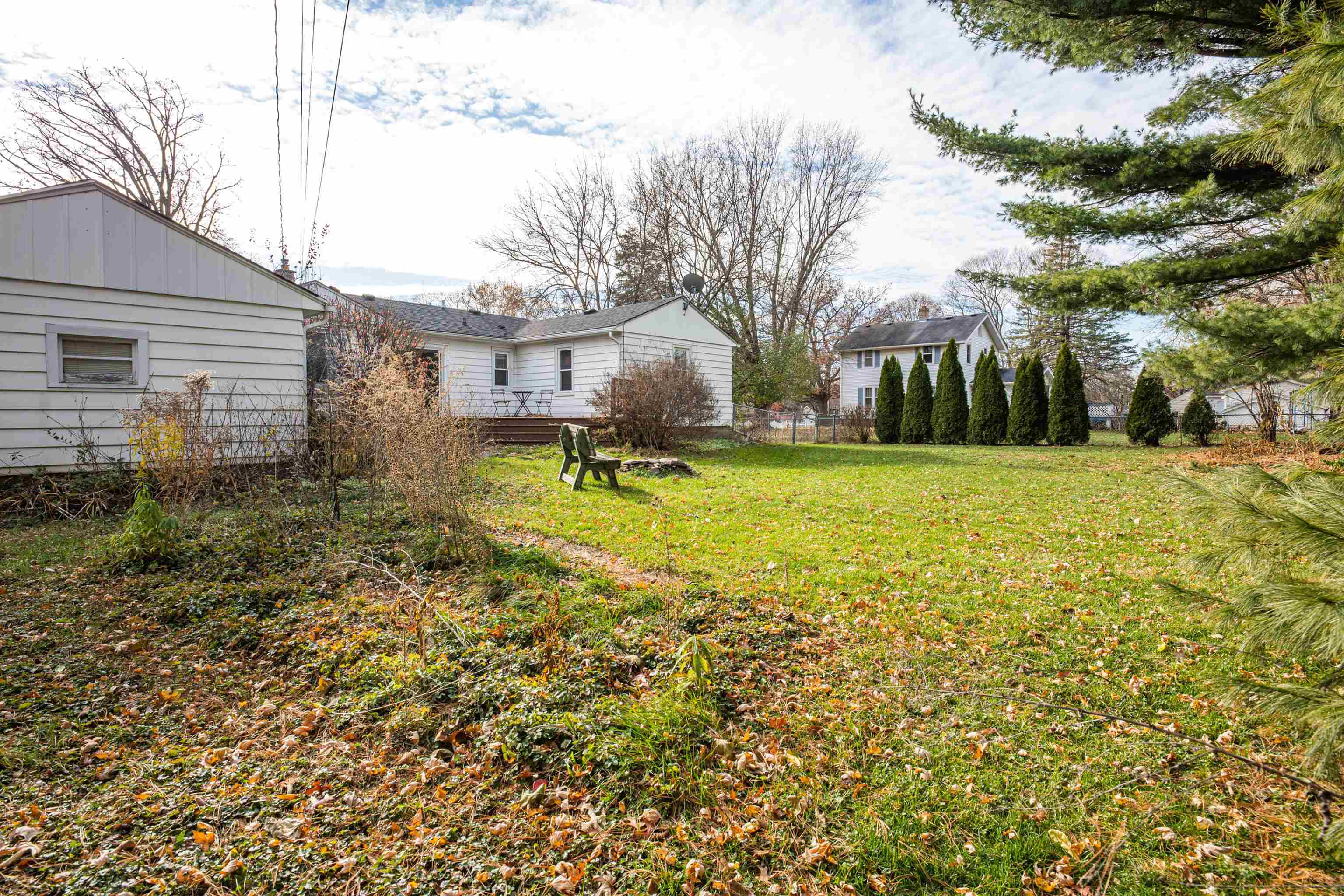 3808 Highcrest Road Rockford, IL 61107 - Photo 4 of 34 a backyard of a house with yard and outdoor seating