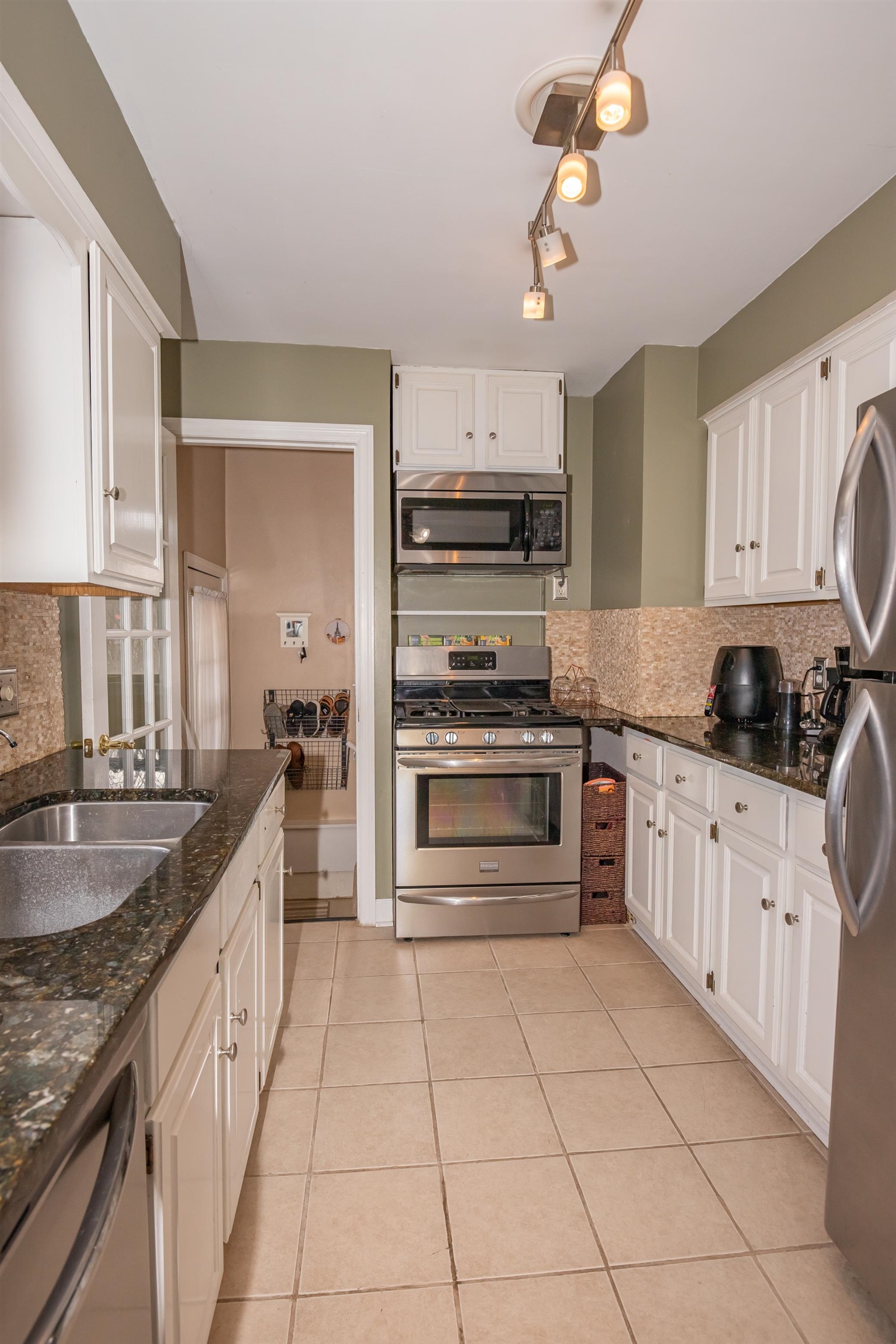 3808 Highcrest Road Rockford, IL 61107 - Photo 10 of 34 a kitchen with kitchen island granite countertop a stove top oven a sink a counter space and cabinets