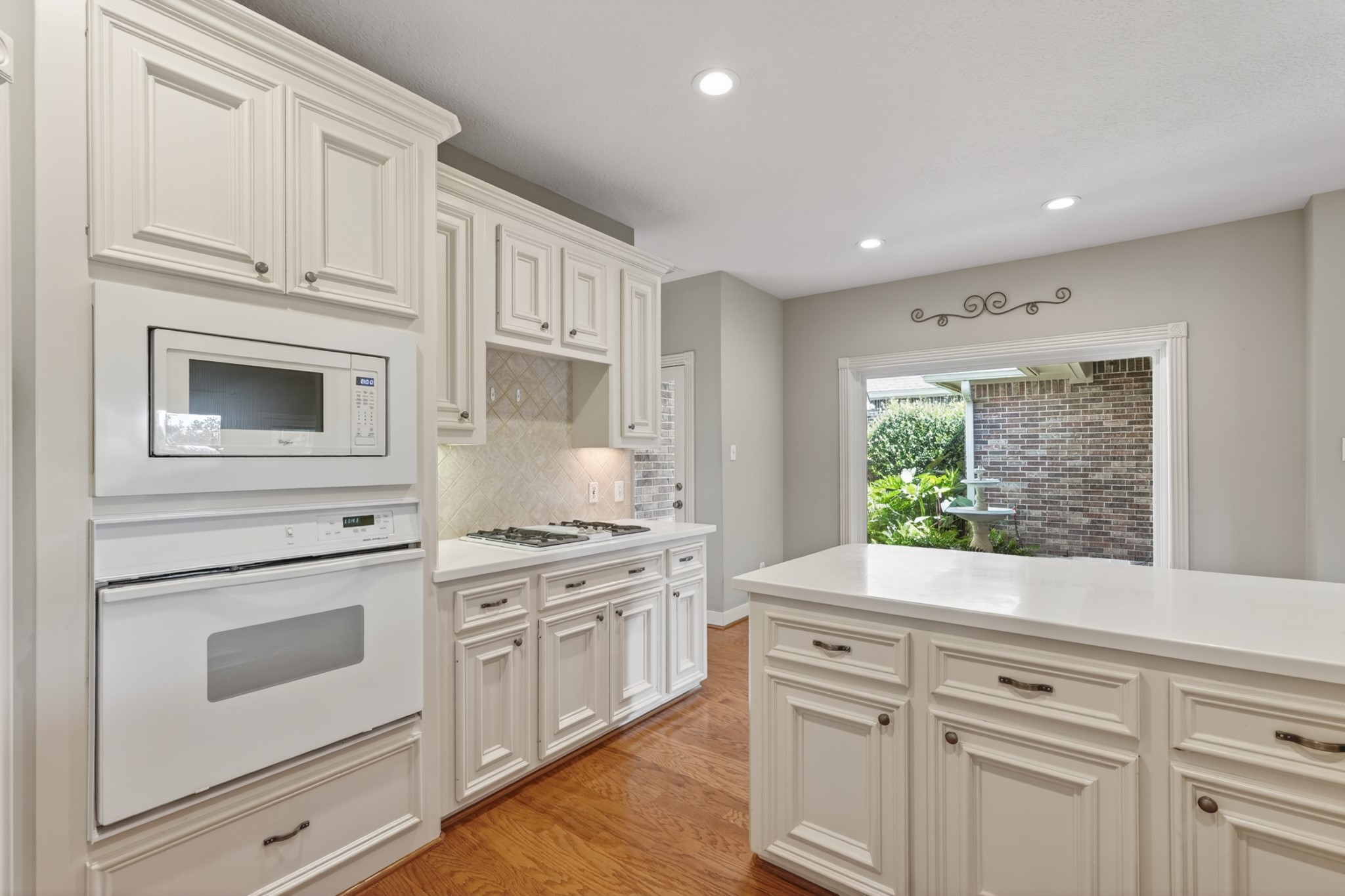 20714 Flora View Court Spring, TX 77379 - Photo 21 of 40 a kitchen with white cabinets and white appliances