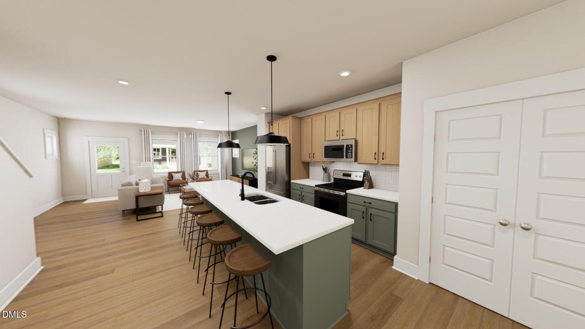 833 Central Park Drive Raleigh, NC 27604 - Photo 5 of 20 a kitchen with a table chairs refrigerator and cabinets