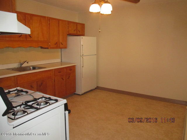 6 D Walnut Road Manahawkin, NJ 08050 - Photo 4 of 7 a kitchen with a stove and a refrigerator