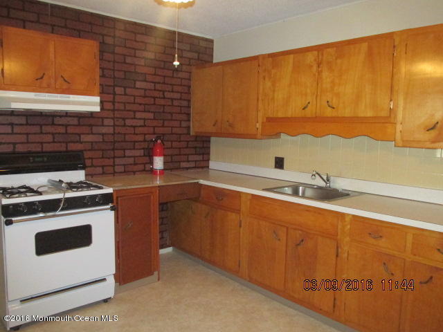 6 D Walnut Road Manahawkin, NJ 08050 - Photo 5 of 7 a kitchen with a sink stove and cabinets