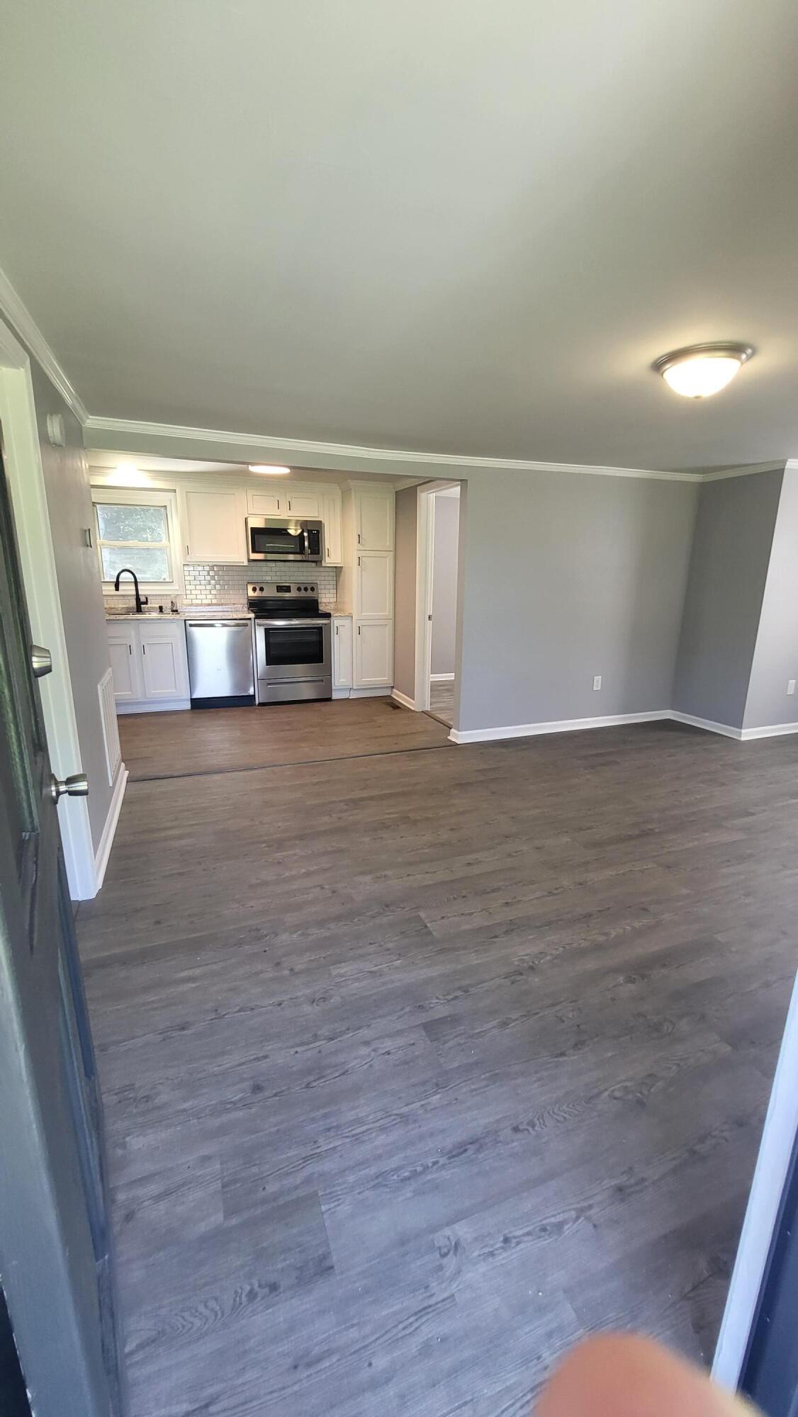7588 Venable Road Kents Store, VA 23084 - Photo 12 of 38 a view of a livingroom with wooden floor and a ceiling fan