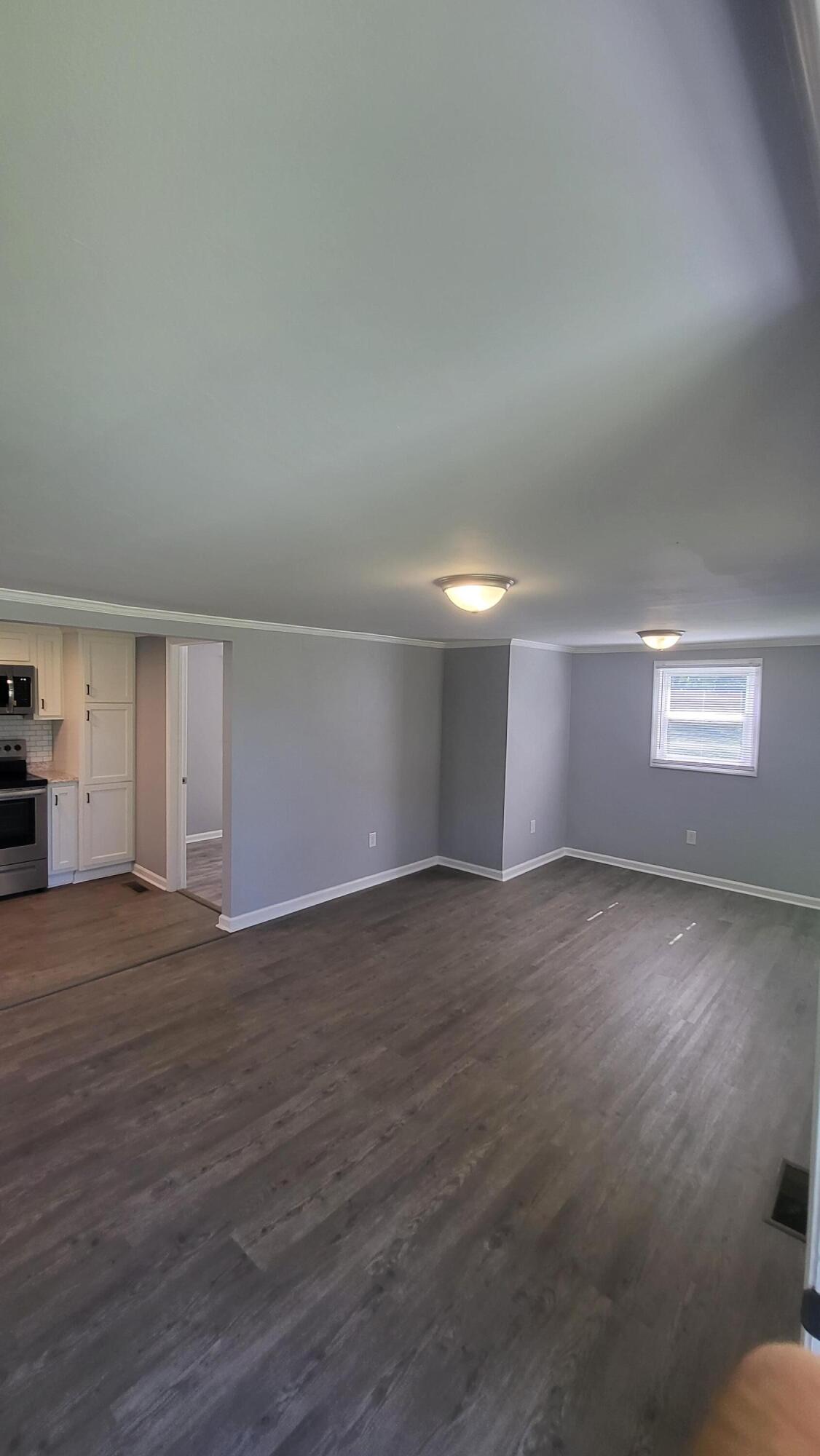 7588 Venable Road Kents Store, VA 23084 - Photo 14 of 38 an empty room with wooden floor and windows
