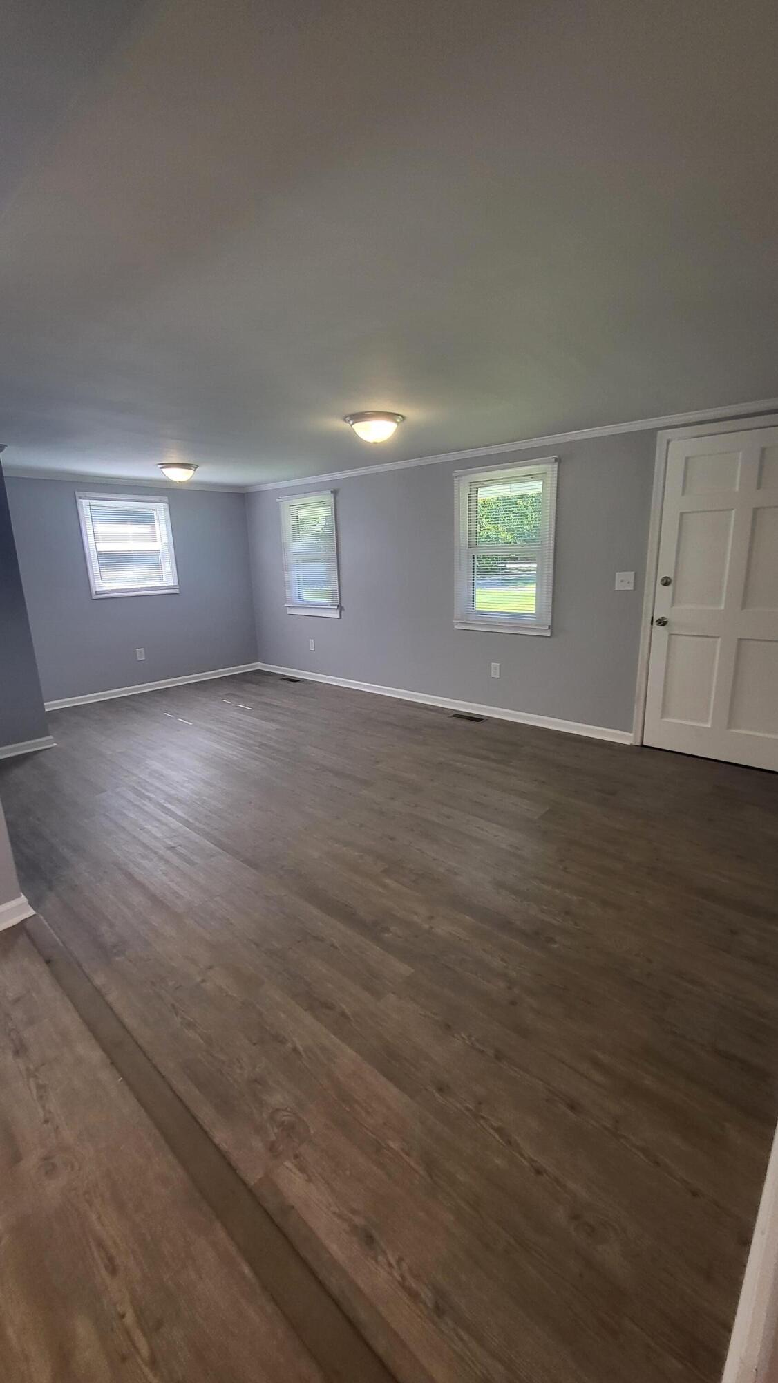 7588 Venable Road Kents Store, VA 23084 - Photo 15 of 38 an empty room with wooden floor and windows