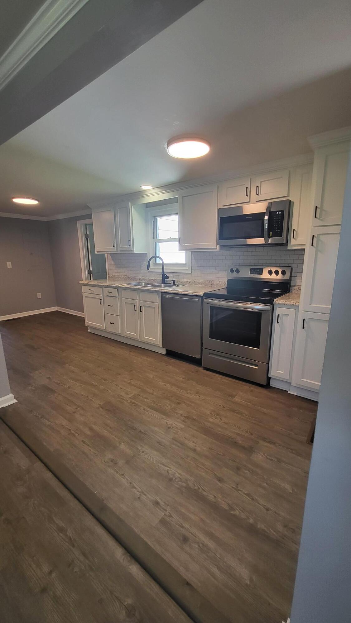 7588 Venable Road Kents Store, VA 23084 - Photo 20 of 38 a large kitchen with stainless steel appliances granite countertop a stove a sink and a refrigerator