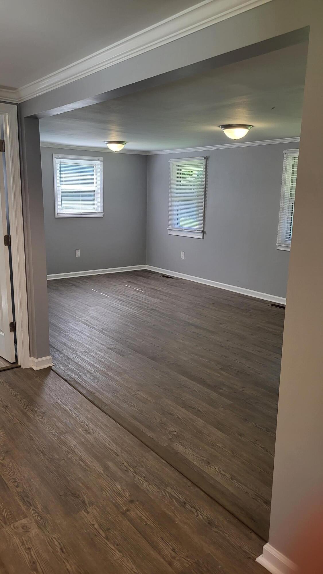 7588 Venable Road Kents Store, VA 23084 - Photo 21 of 38 a view of an empty room with wooden floor and a window