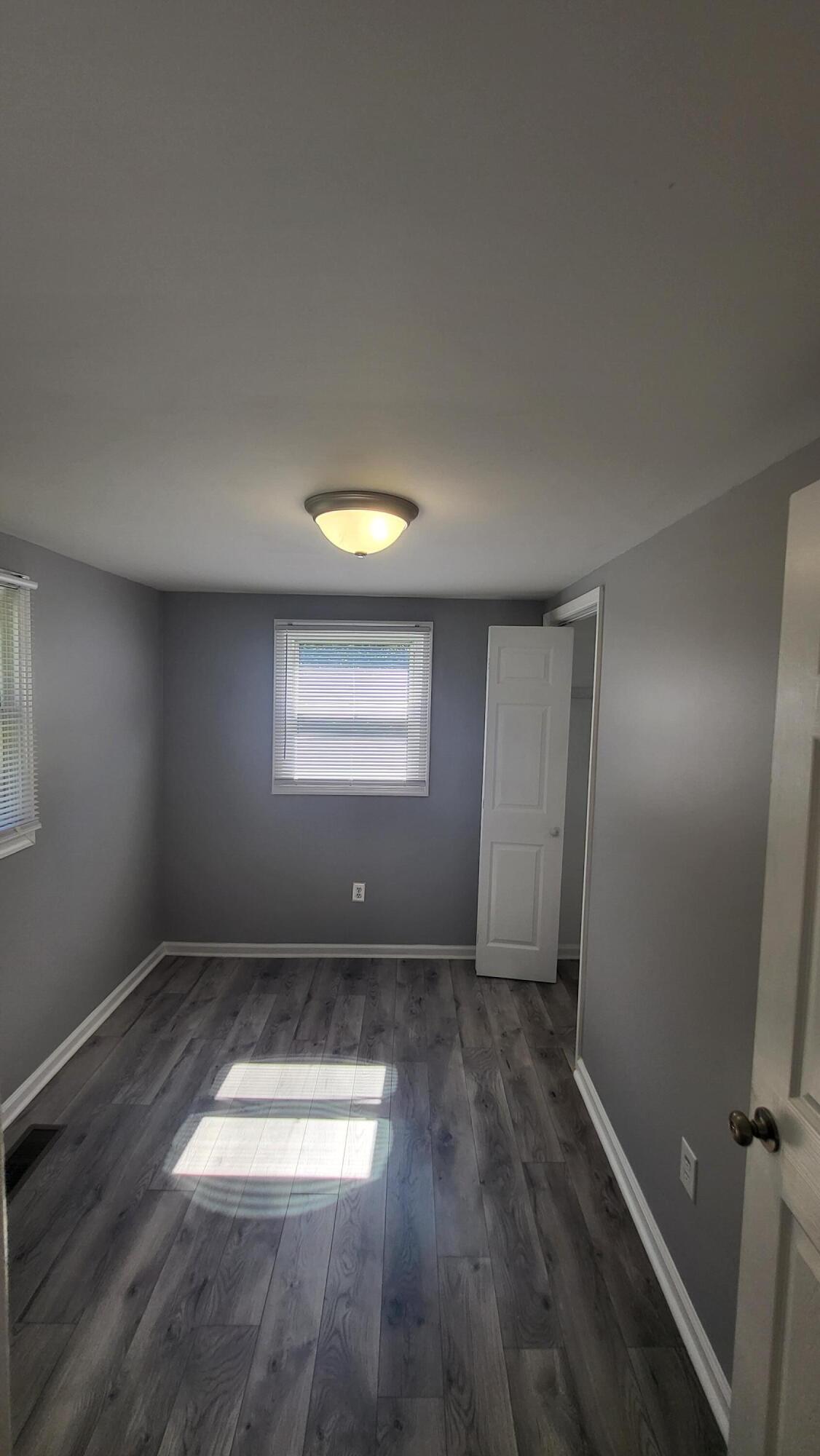 7588 Venable Road Kents Store, VA 23084 - Photo 25 of 38 an empty room with wooden floor and windows