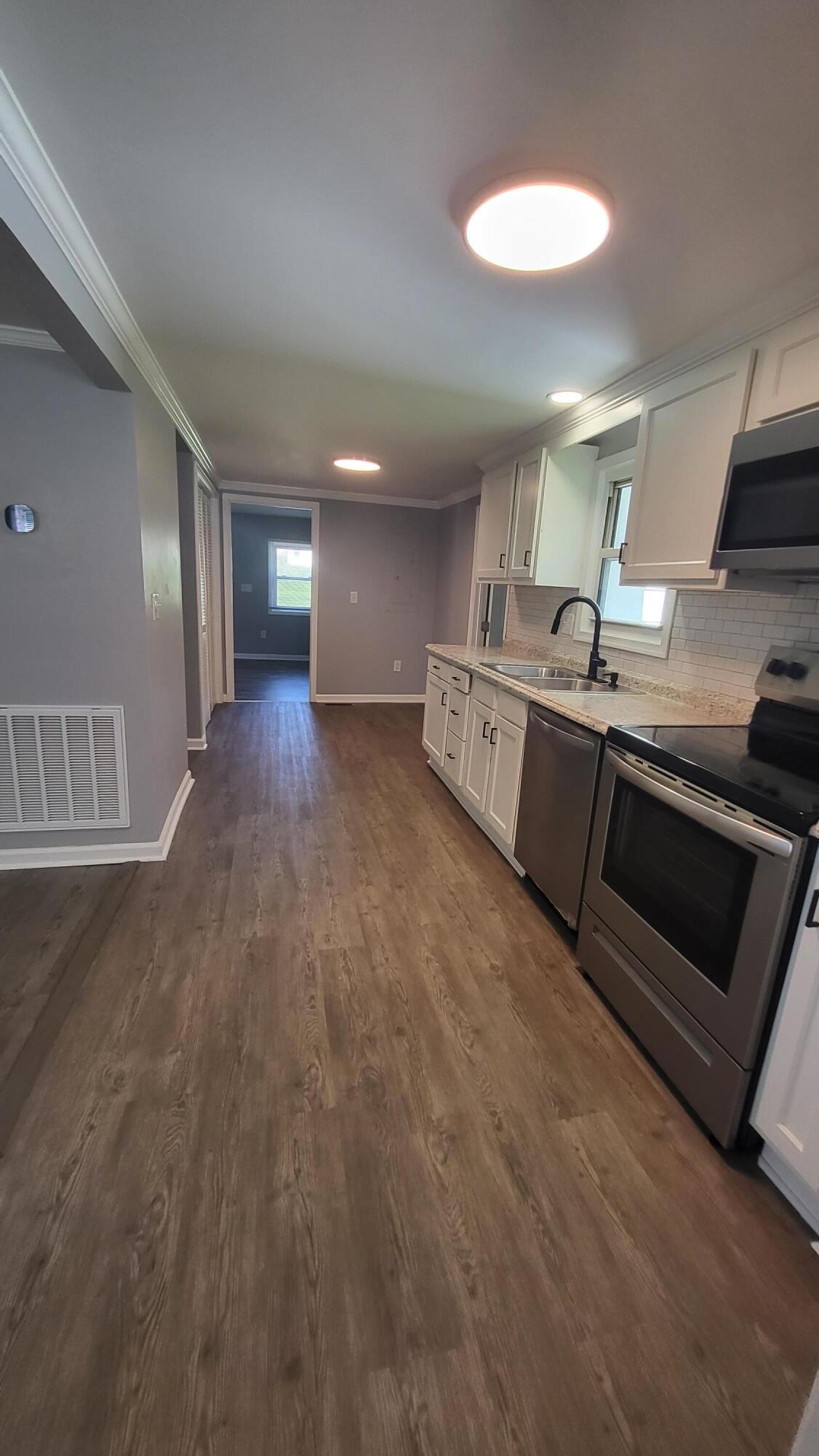7588 Venable Road Kents Store, VA 23084 - Photo 26 of 38 a large kitchen with stainless steel appliances a large counter top