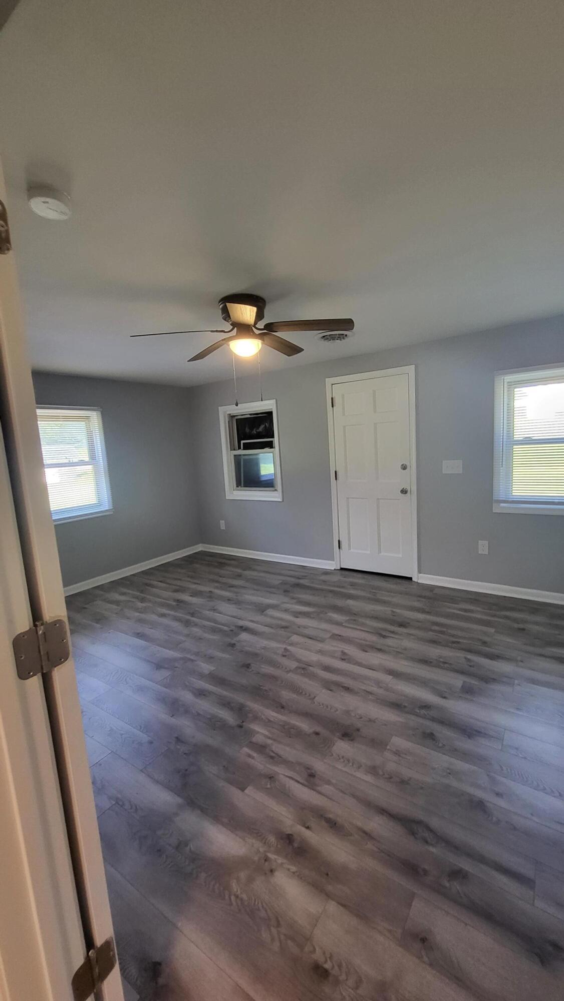 7588 Venable Road Kents Store, VA 23084 - Photo 33 of 38 a view of an empty room with window and wooden floor