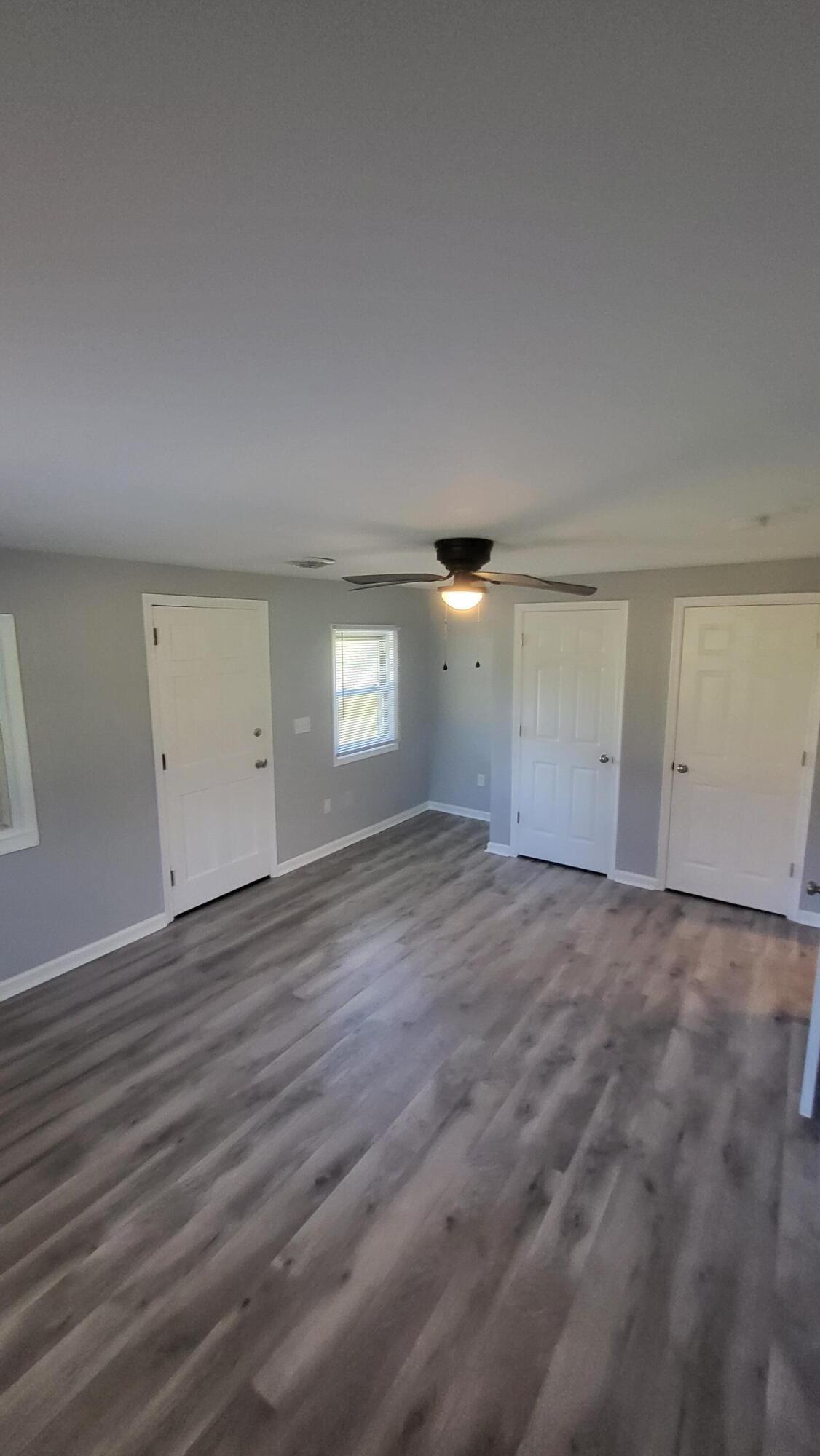 7588 Venable Road Kents Store, VA 23084 - Photo 34 of 38 an empty room with wooden floor and windows