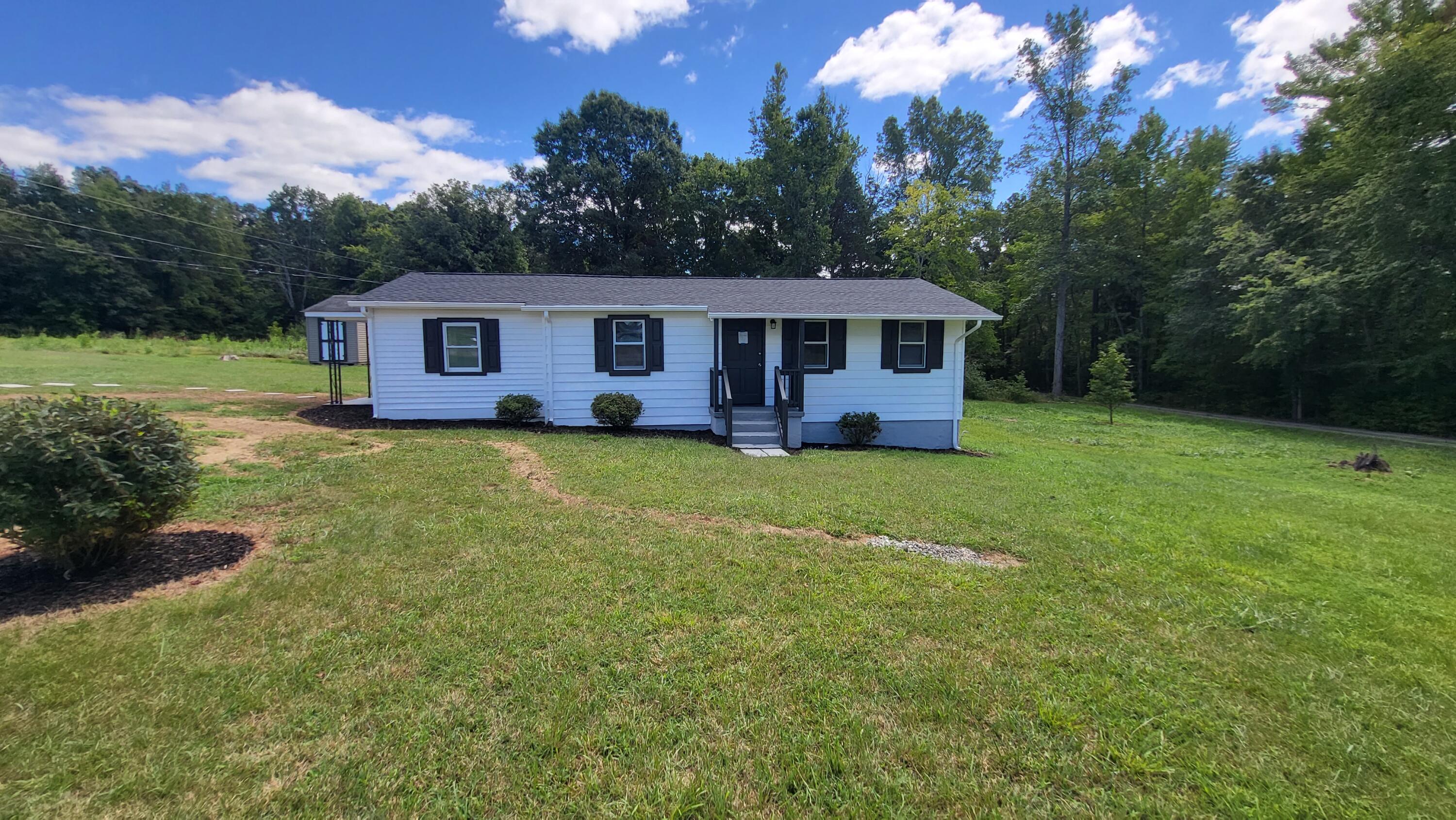 7588 Venable Road Kents Store, VA 23084 - Photo 5 of 38 a front view of a house with garden