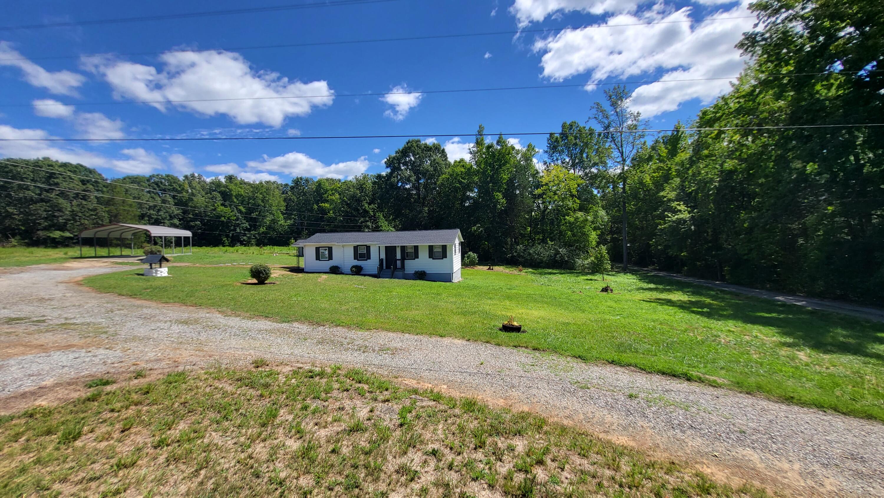 7588 Venable Road Kents Store, VA 23084 - Photo 8 of 38 a green field with lots of trees in the background