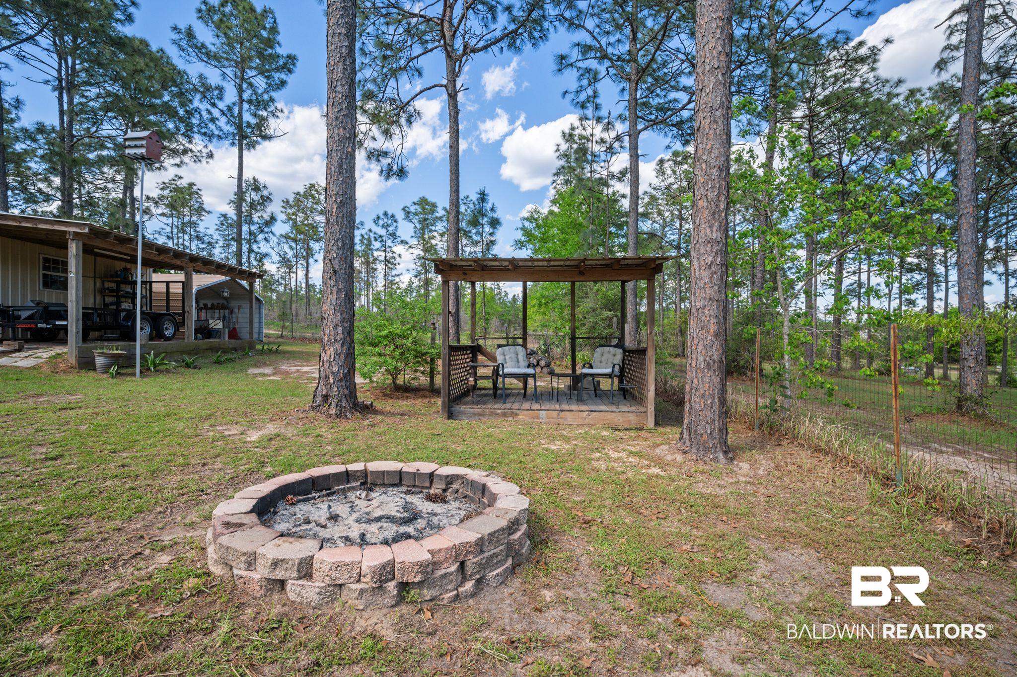 3100 Radcliff Road Saraland, AL 36571 - Photo 47 of 65 View of yard with a deck and a fire pit