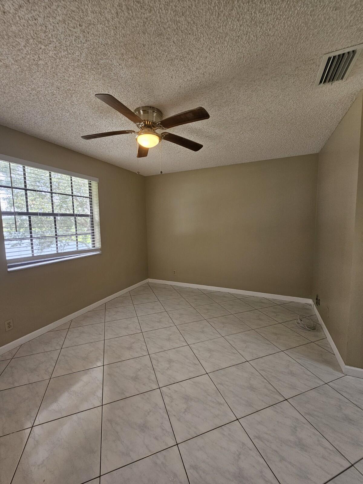3150 Leewood Terrace, Unit L222 Boca Raton, FL 33431 - Photo 11 of 39 a view of an empty room with a window