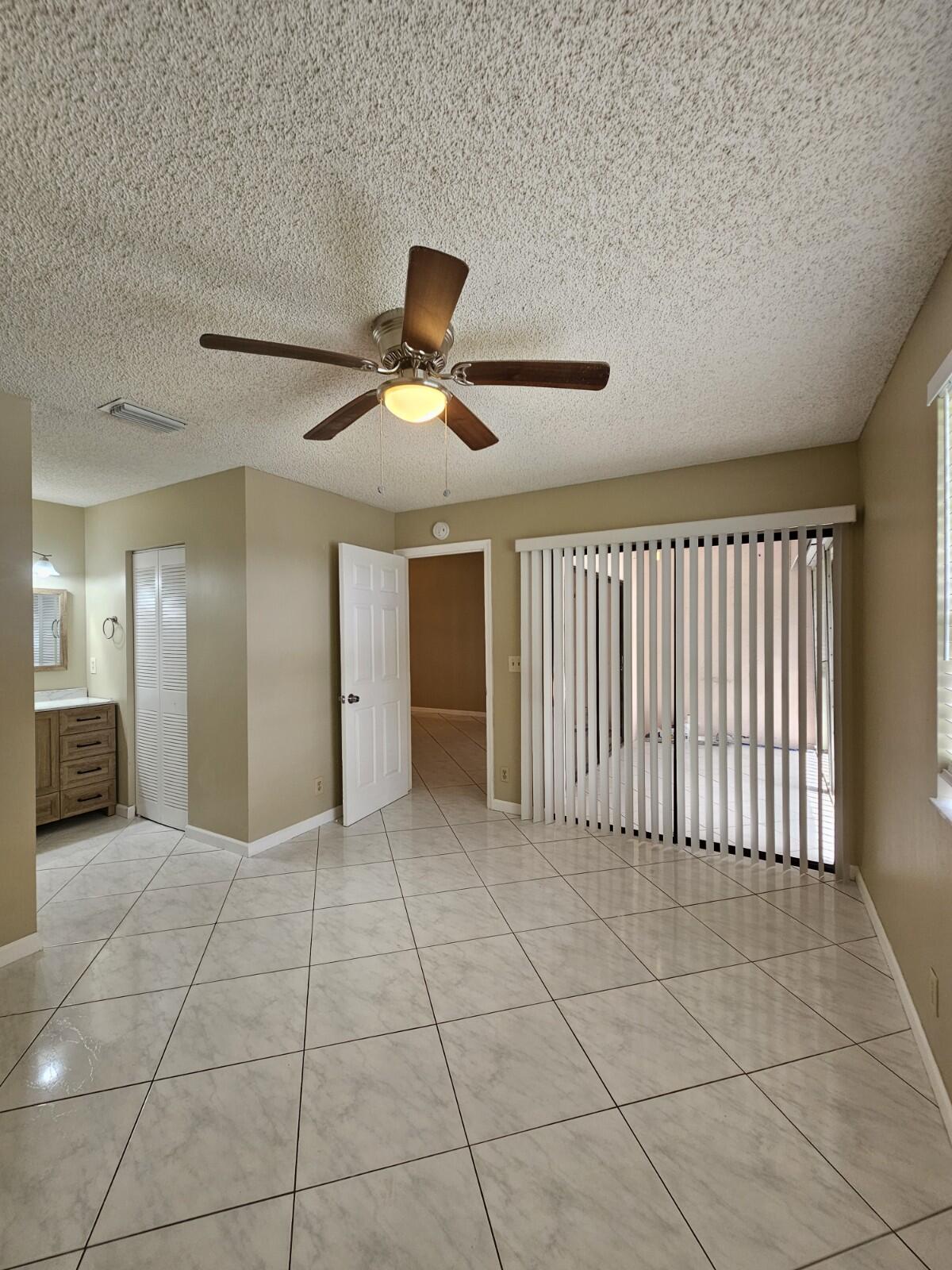 3150 Leewood Terrace, Unit L222 Boca Raton, FL 33431 - Photo 12 of 39 a view of a livingroom with a ceiling fan and window