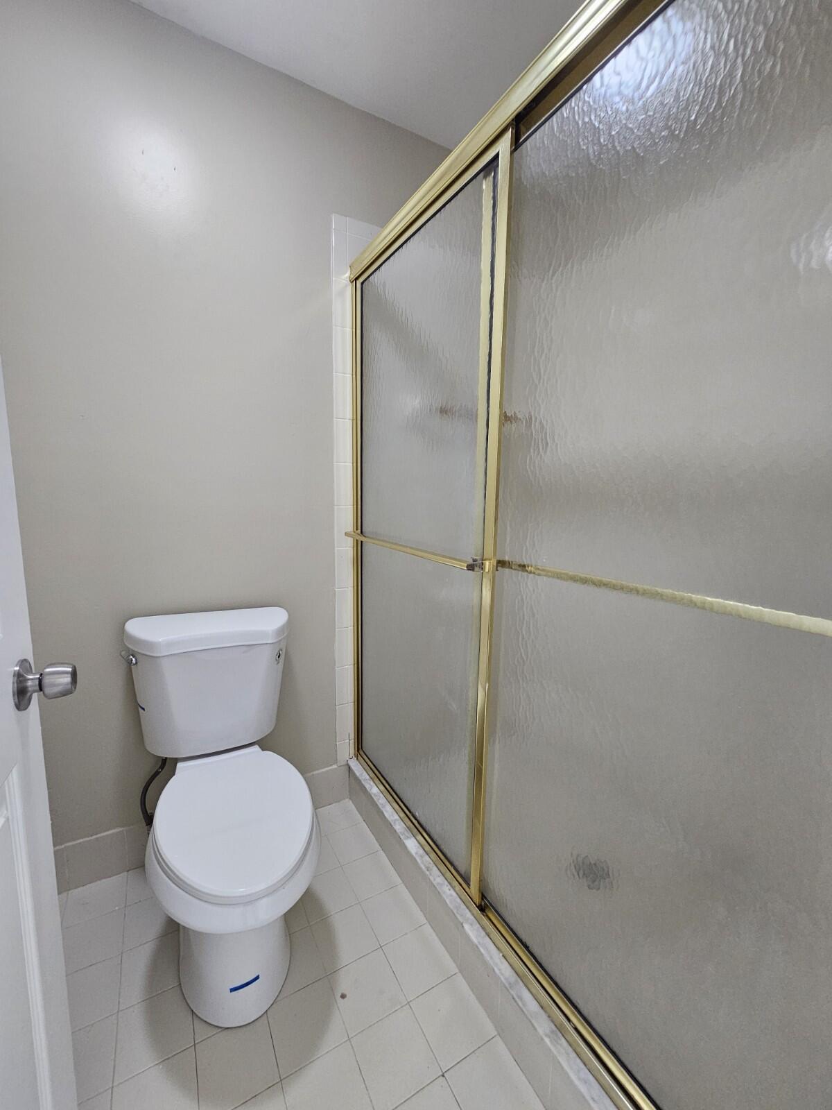 3150 Leewood Terrace, Unit L222 Boca Raton, FL 33431 - Photo 16 of 39 a bathroom with a toilet and a shower
