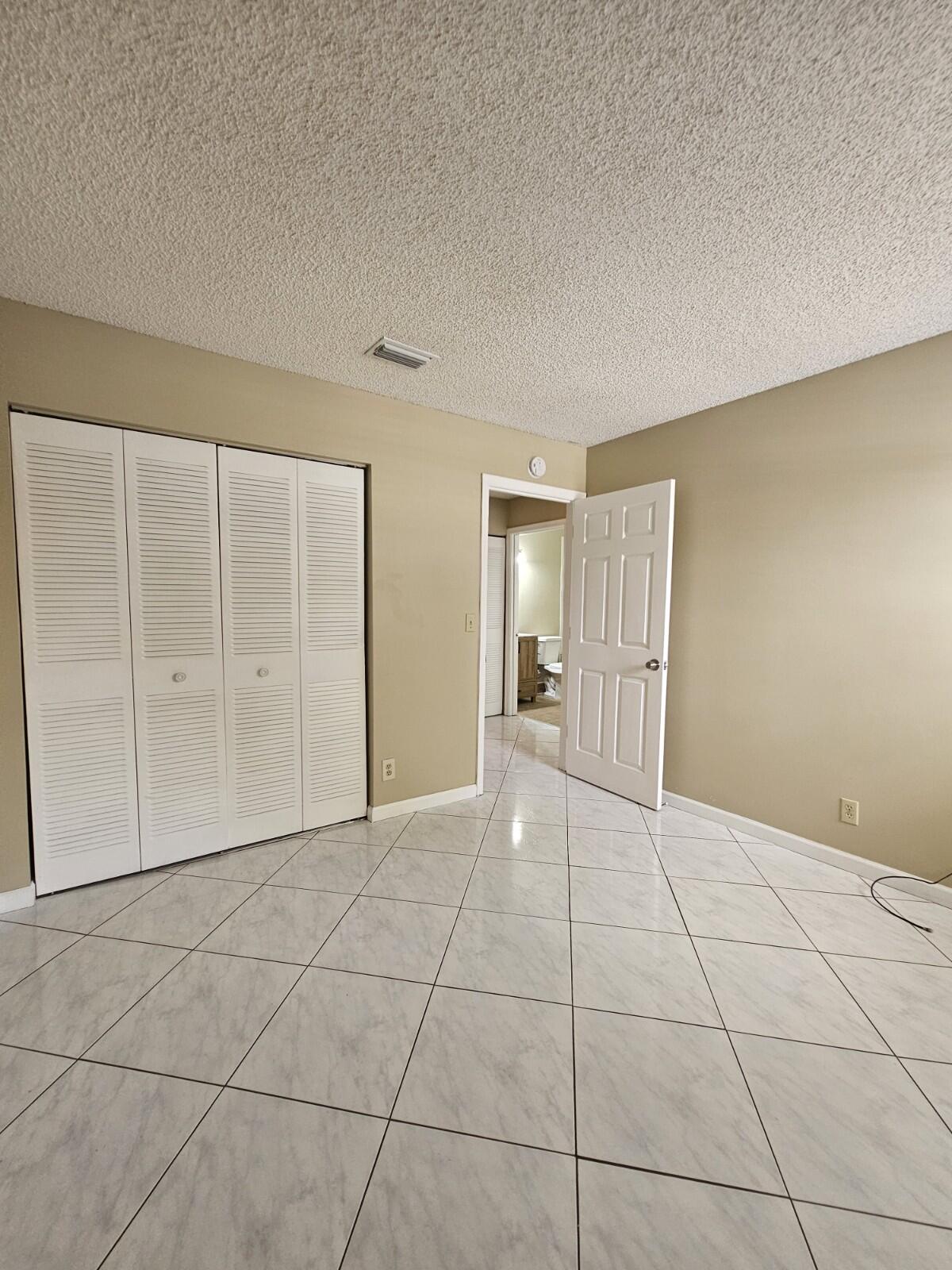 3150 Leewood Terrace, Unit L222 Boca Raton, FL 33431 - Photo 21 of 39 a view of an empty room with cabinet and a bathroom
