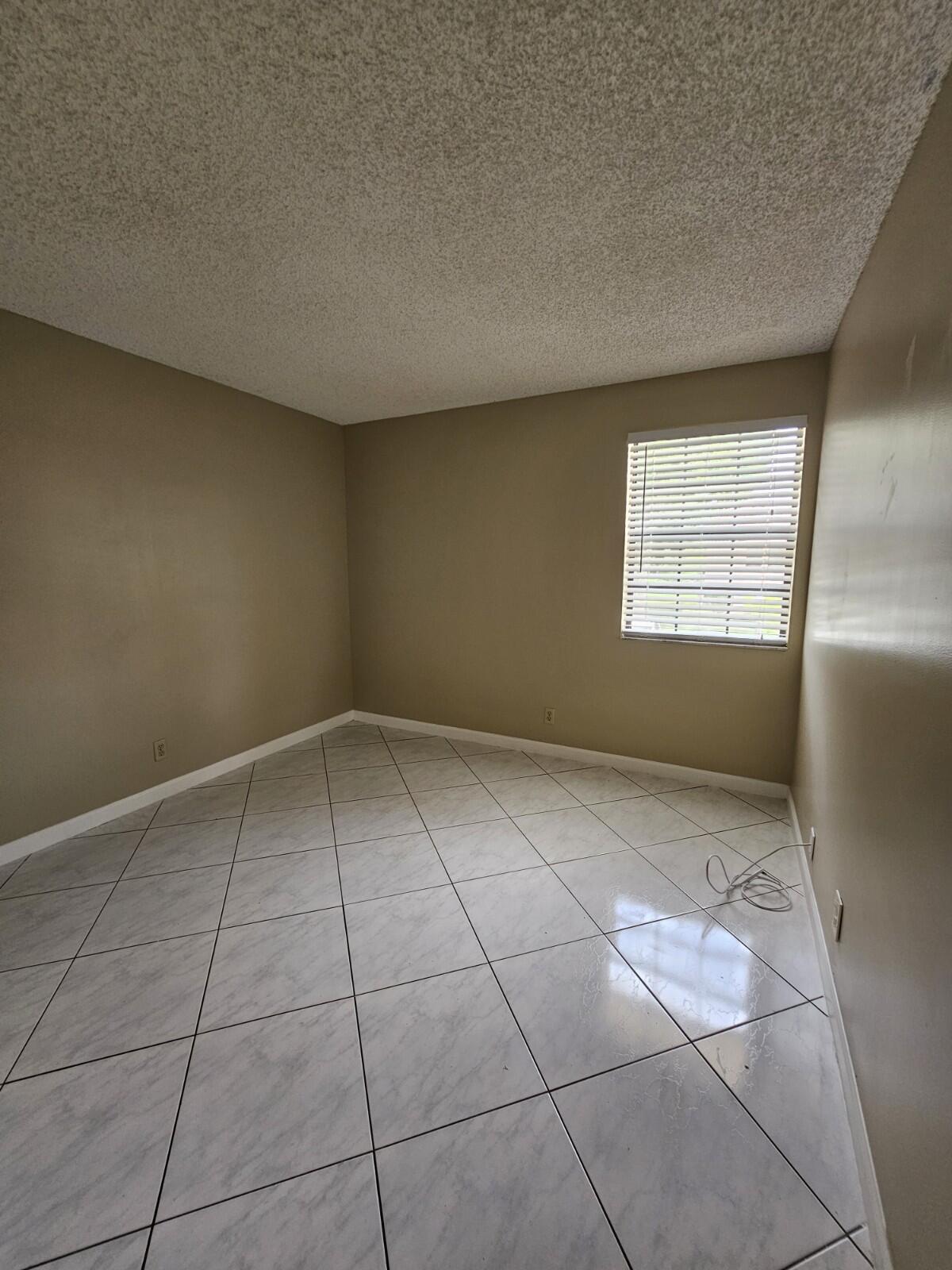 3150 Leewood Terrace, Unit L222 Boca Raton, FL 33431 - Photo 24 of 39 a view of an empty room and window