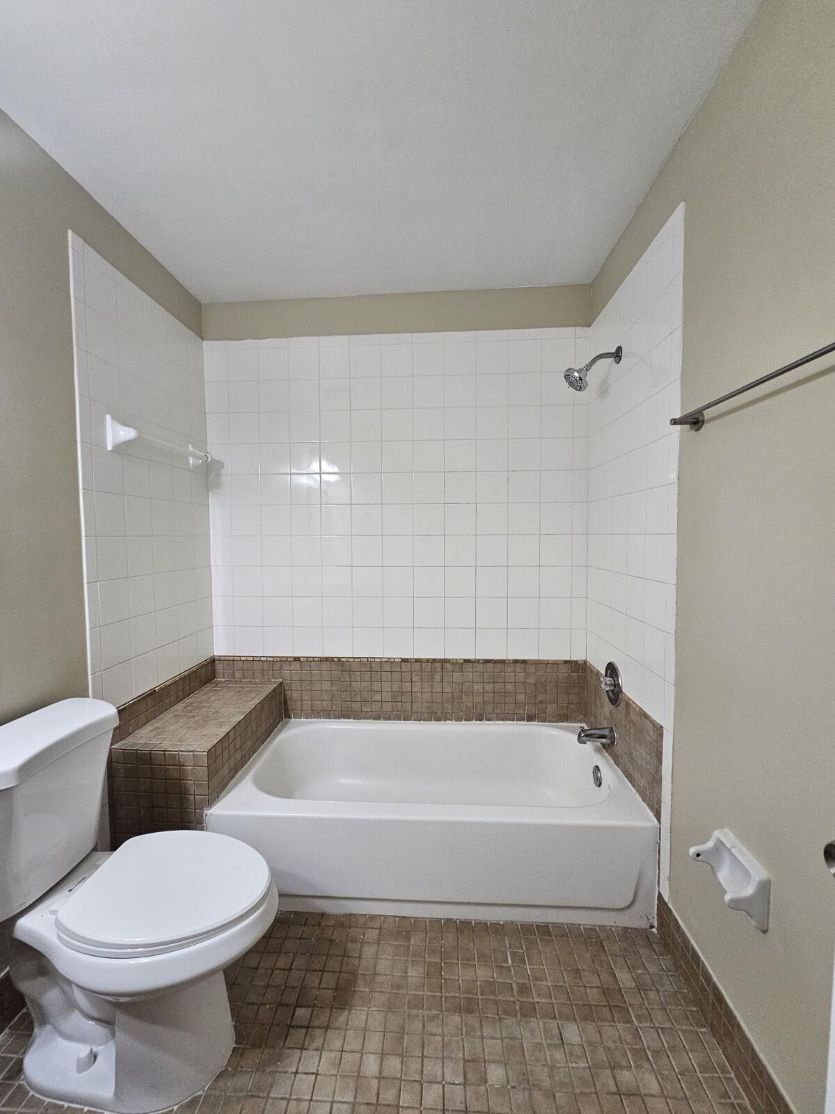 3150 Leewood Terrace, Unit L222 Boca Raton, FL 33431 - Photo 26 of 39 a bathroom with a bathtub and a toilet