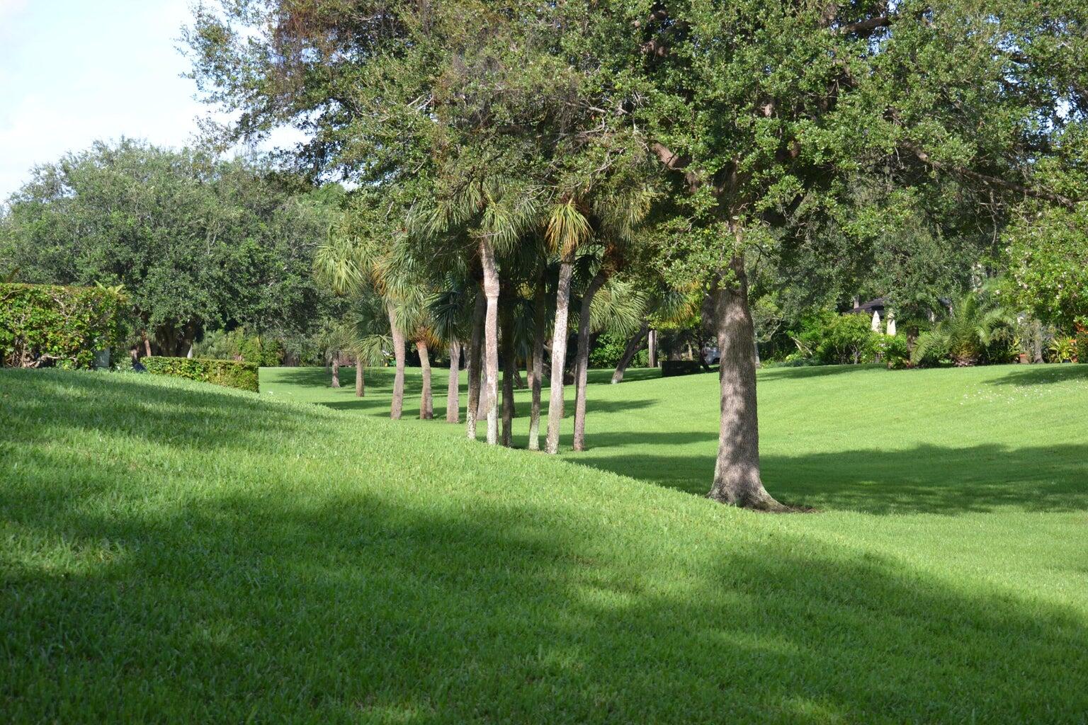 3150 Leewood Terrace, Unit L222 Boca Raton, FL 33431 - Photo 31 of 39 a view of a park with trees and grass