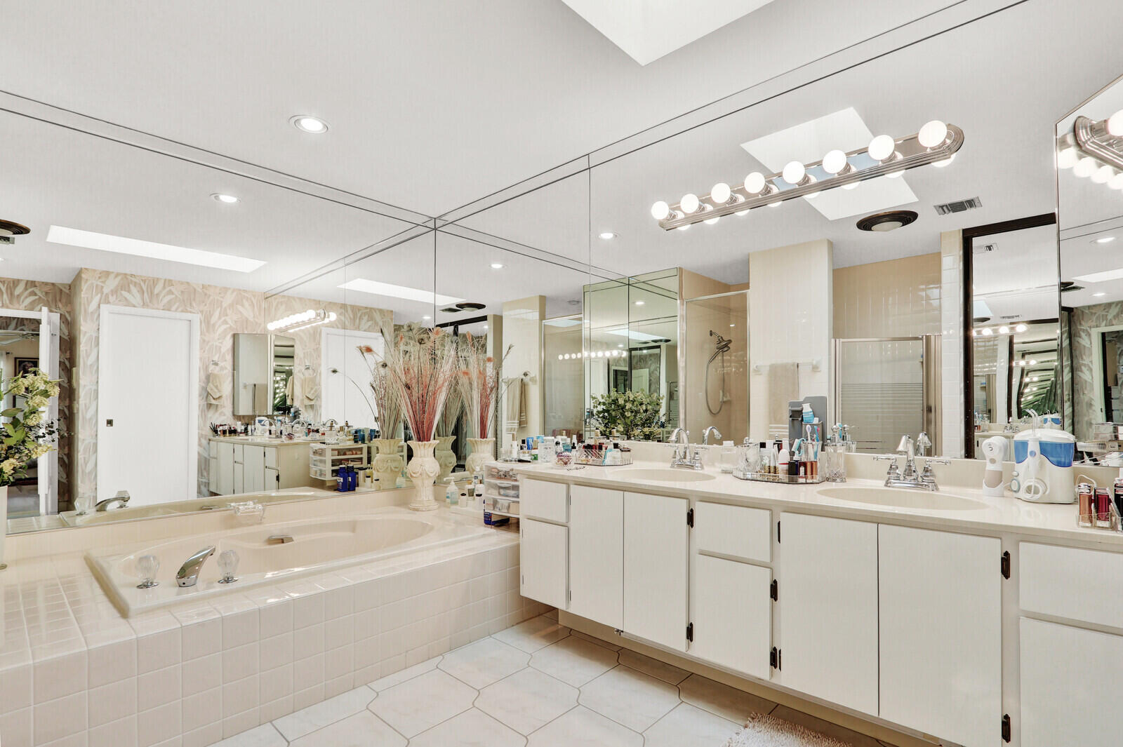 352 River Edge Road Jupiter, FL 33477 - Photo 46 of 50 a bathroom with a large tub sink vanity granite and a mirror