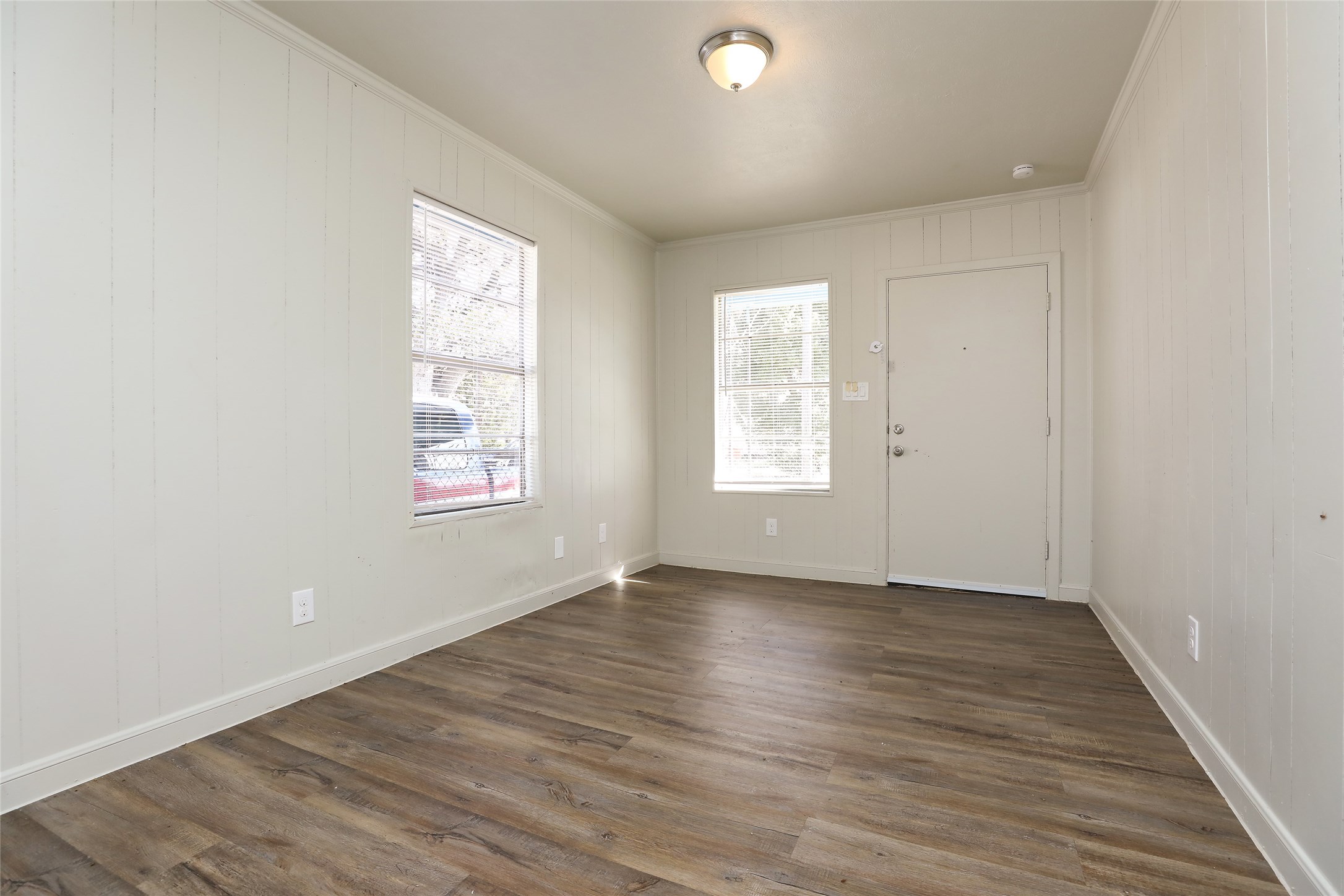 3606 Live Oak Street Houston, TX 77004 - Photo 3 of 15 an empty room with wooden floor and windows