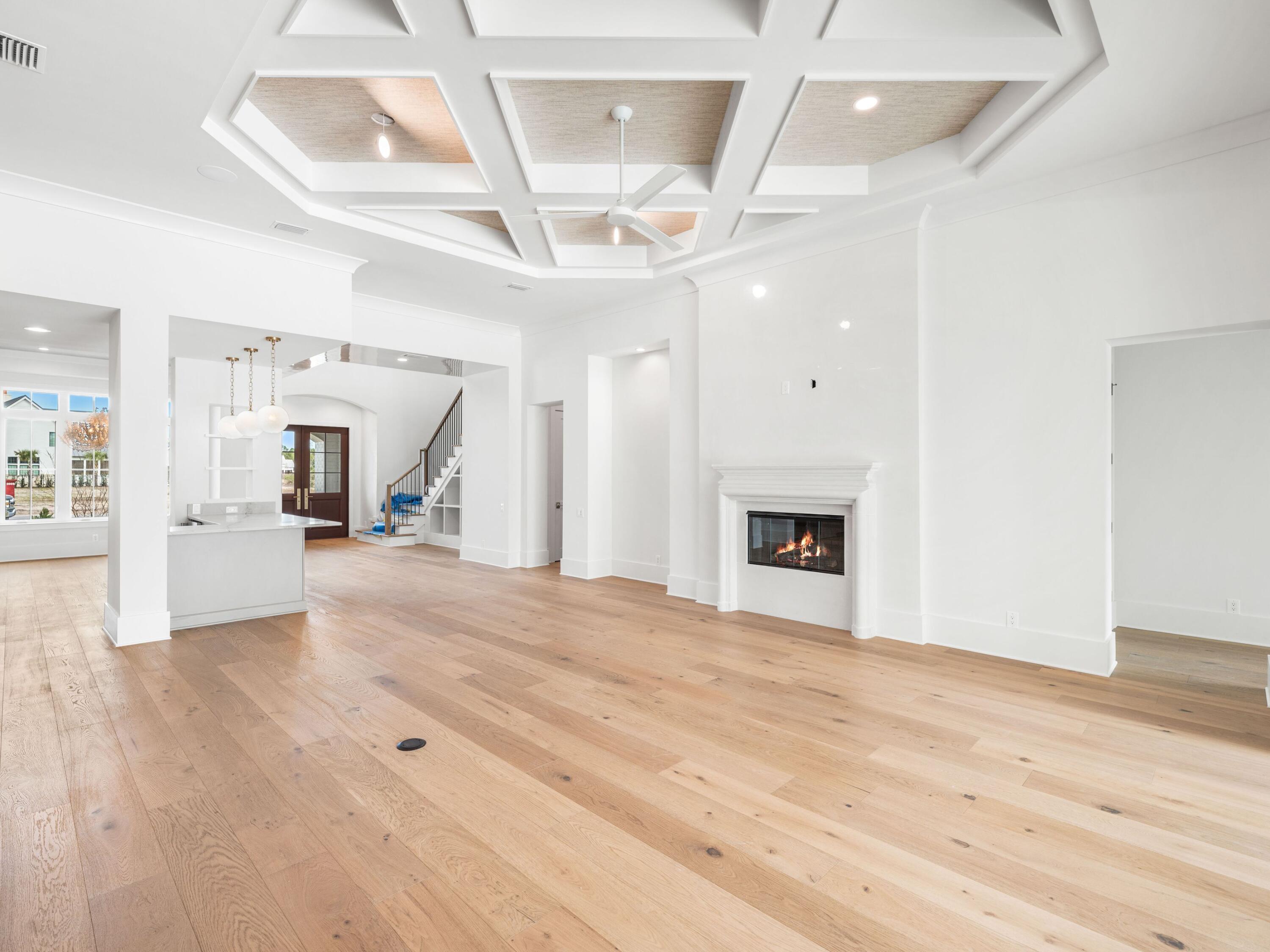 303 Golfridge Drive Watersound, FL 32461 - Photo 12 of 50 a view of a livingroom with a fireplace a ceiling fan and wooden floor