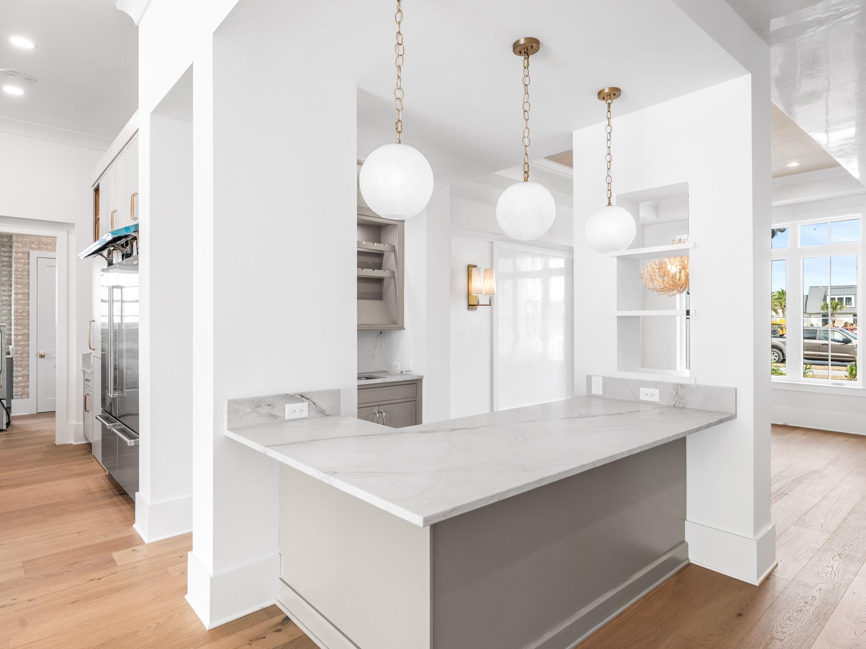 303 Golfridge Drive Watersound, FL 32461 - Photo 17 of 50 a kitchen with a refrigerator a sink and cabinets
