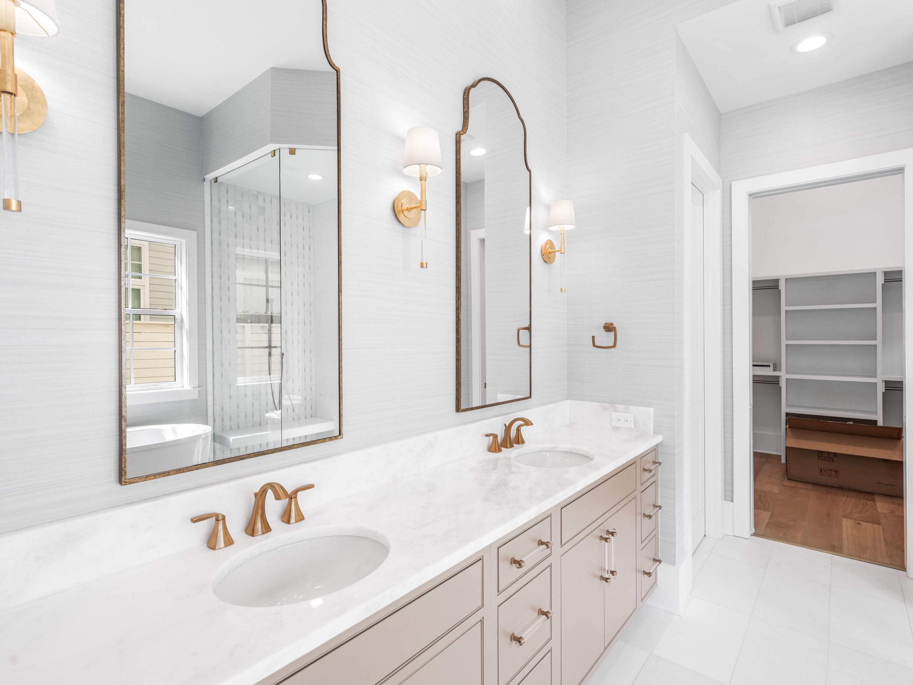 303 Golfridge Drive Watersound, FL 32461 - Photo 22 of 50 a bathroom with a tub sink and mirror