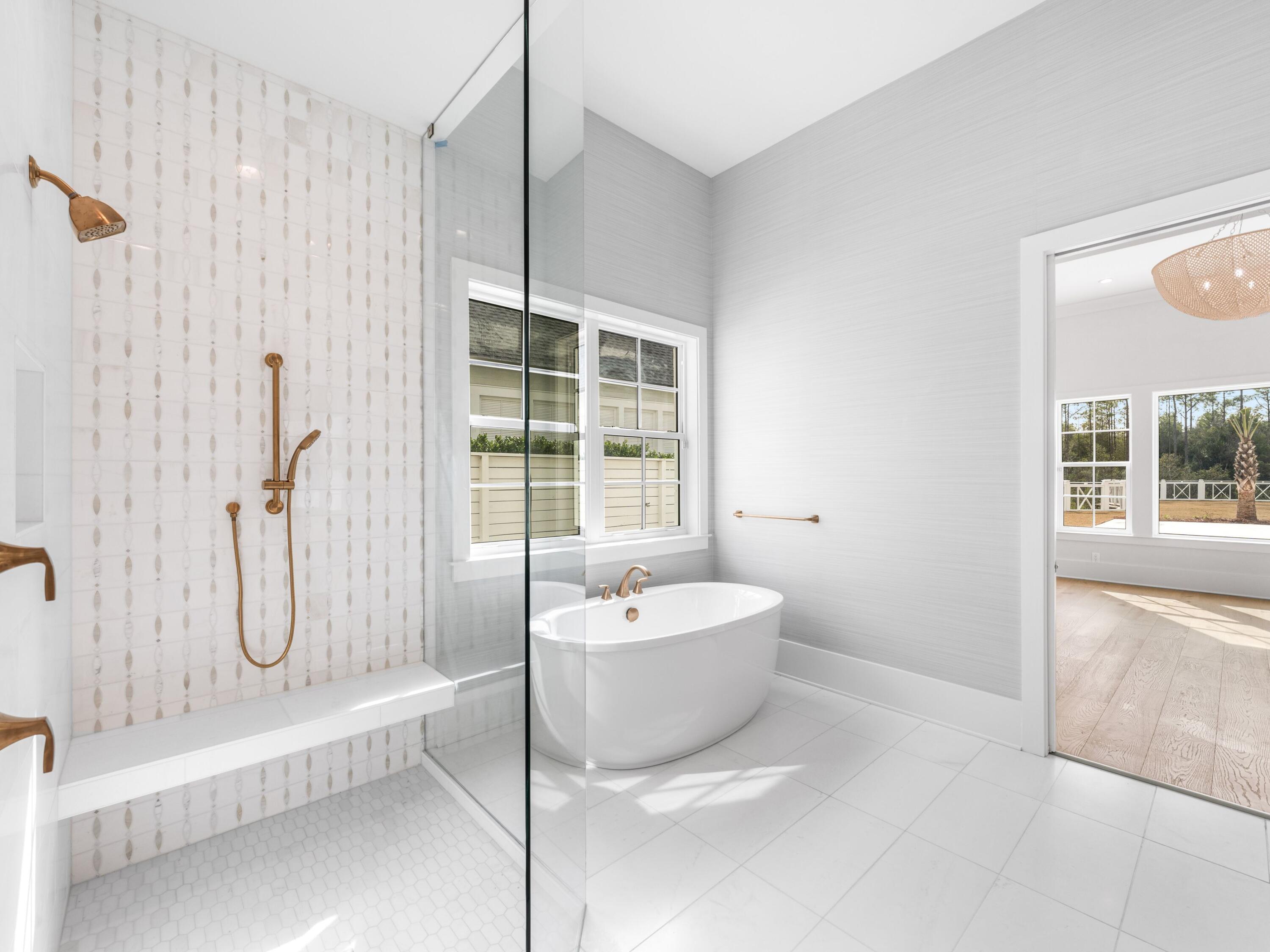 303 Golfridge Drive Watersound, FL 32461 - Photo 24 of 50 a spacious bathroom with a bathtub and a shower