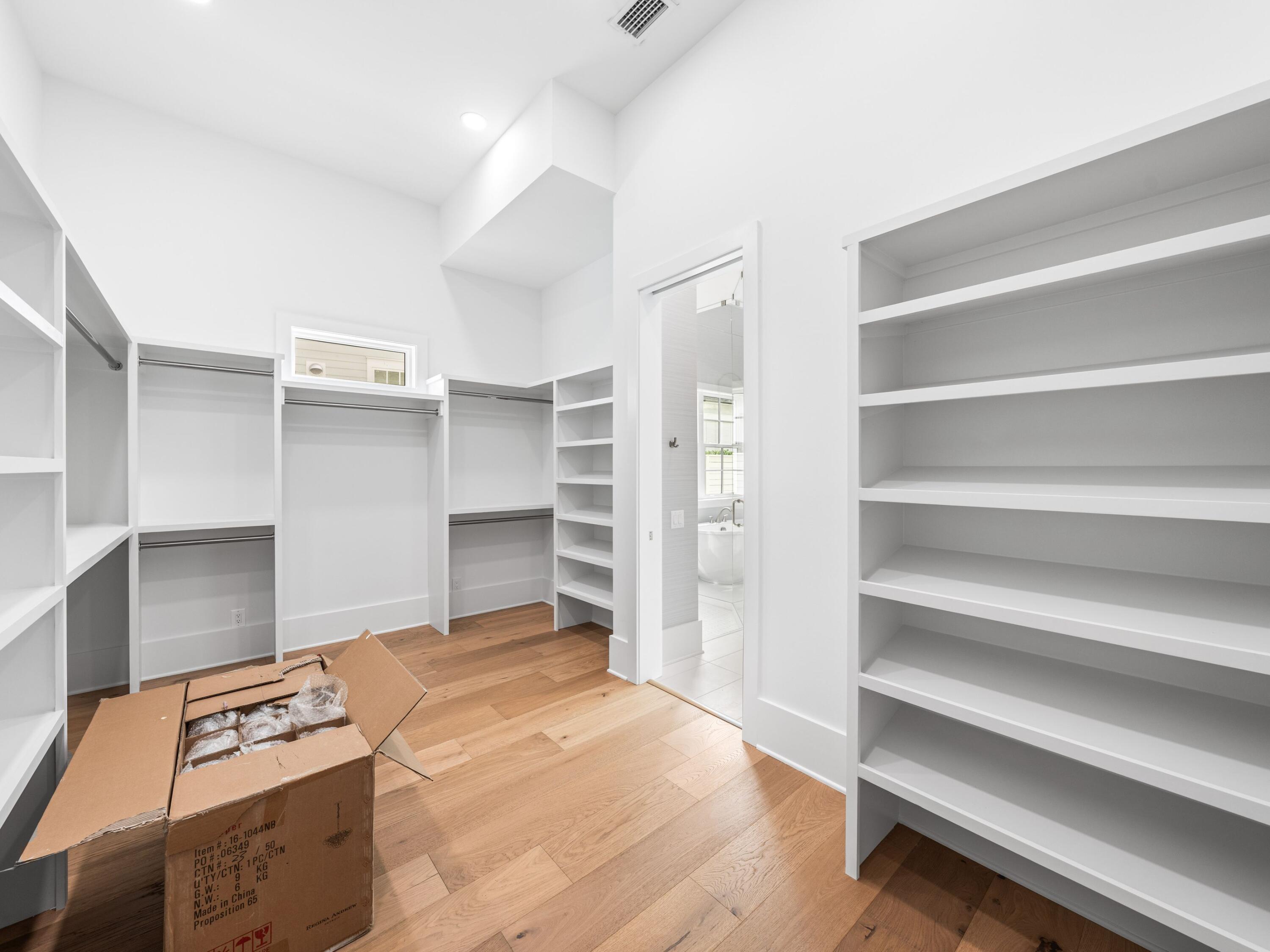 303 Golfridge Drive Watersound, FL 32461 - Photo 25 of 50 a view of walk in closet with empty racks