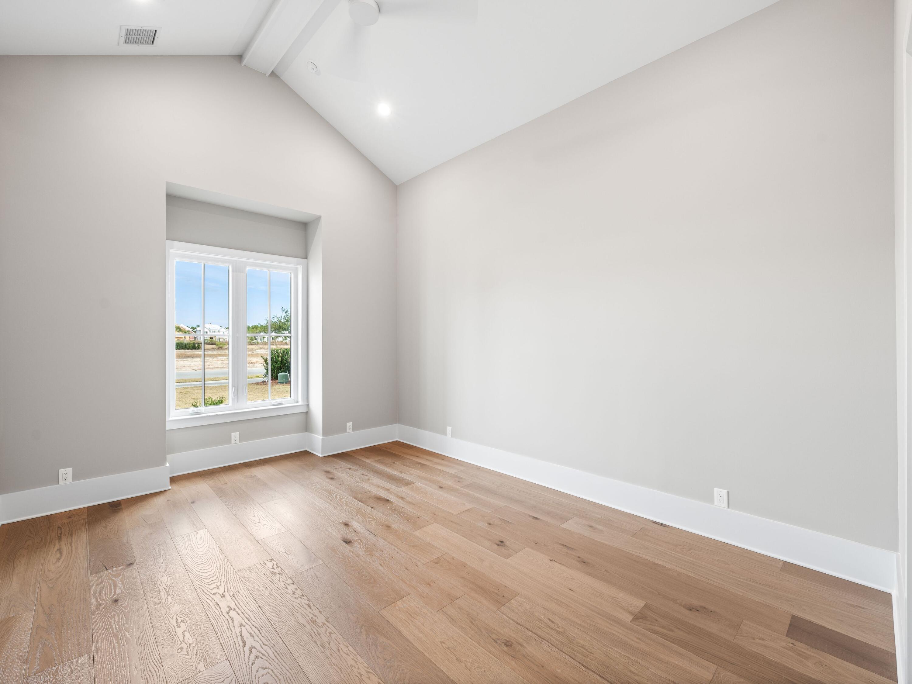 303 Golfridge Drive Watersound, FL 32461 - Photo 27 of 50 an empty room with wooden floor and windows