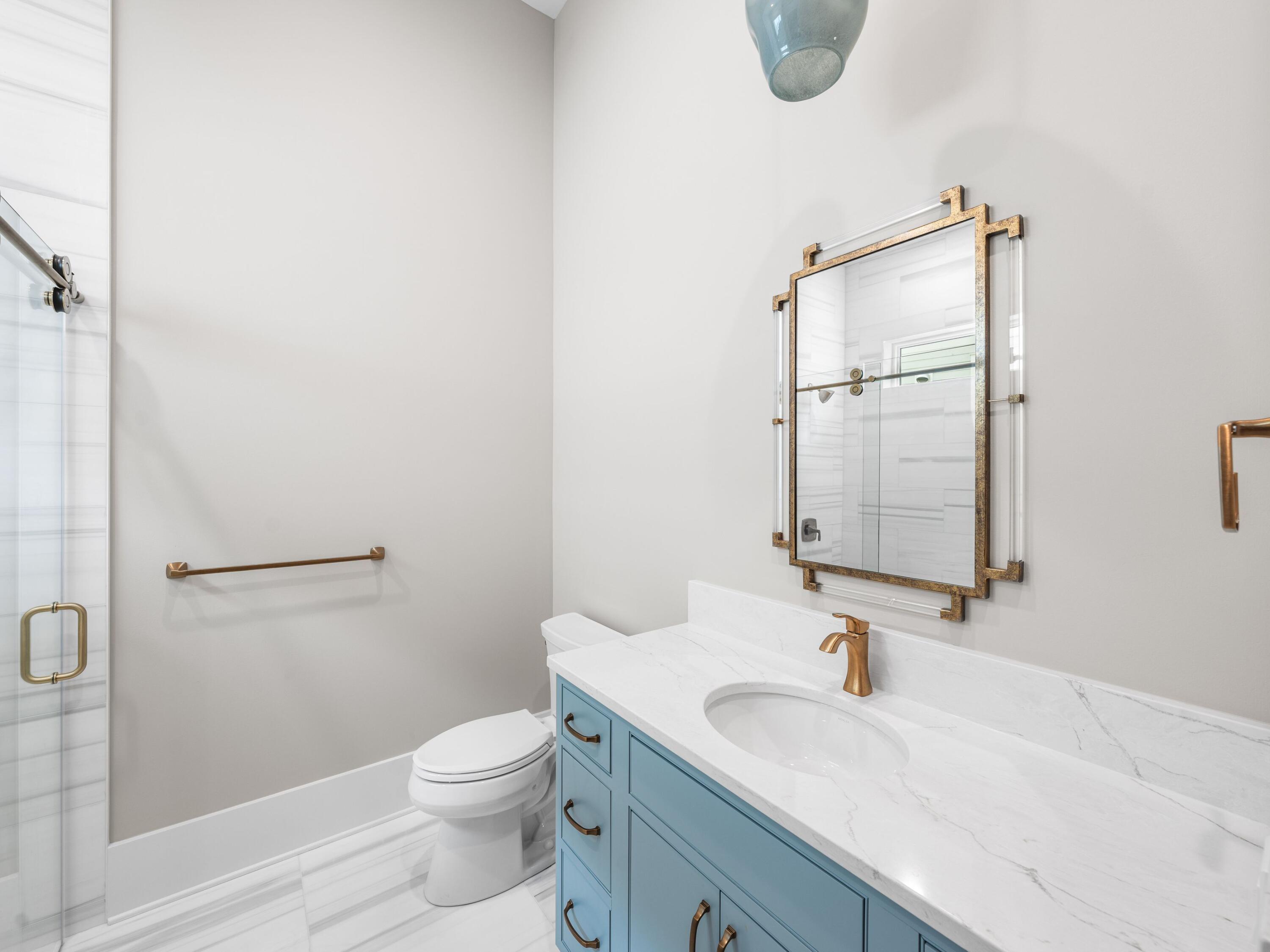 303 Golfridge Drive Watersound, FL 32461 - Photo 28 of 50 a bathroom with a granite countertop sink a toilet and a mirror