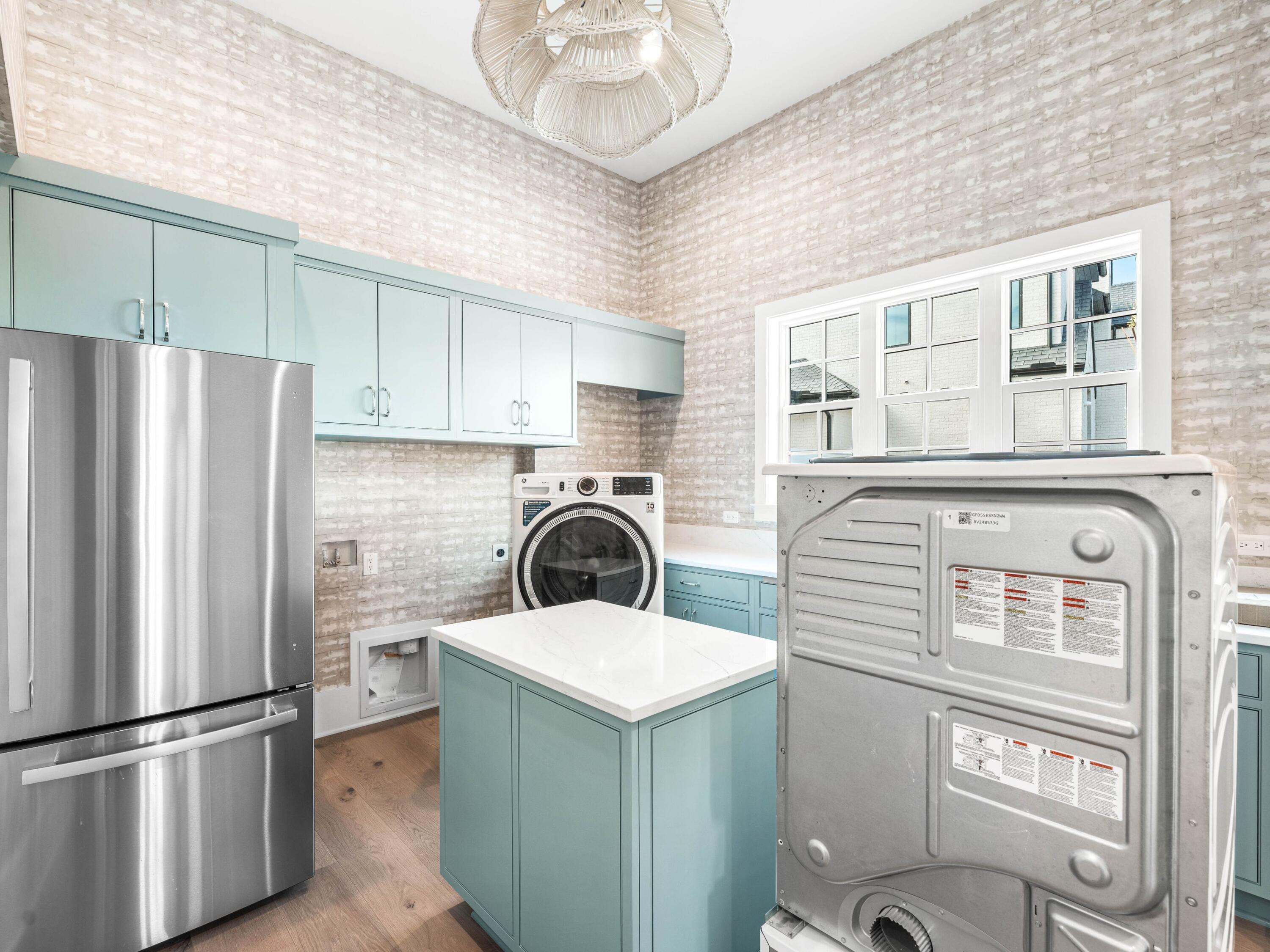 303 Golfridge Drive Watersound, FL 32461 - Photo 30 of 50 a kitchen with a refrigerator sink and cabinets