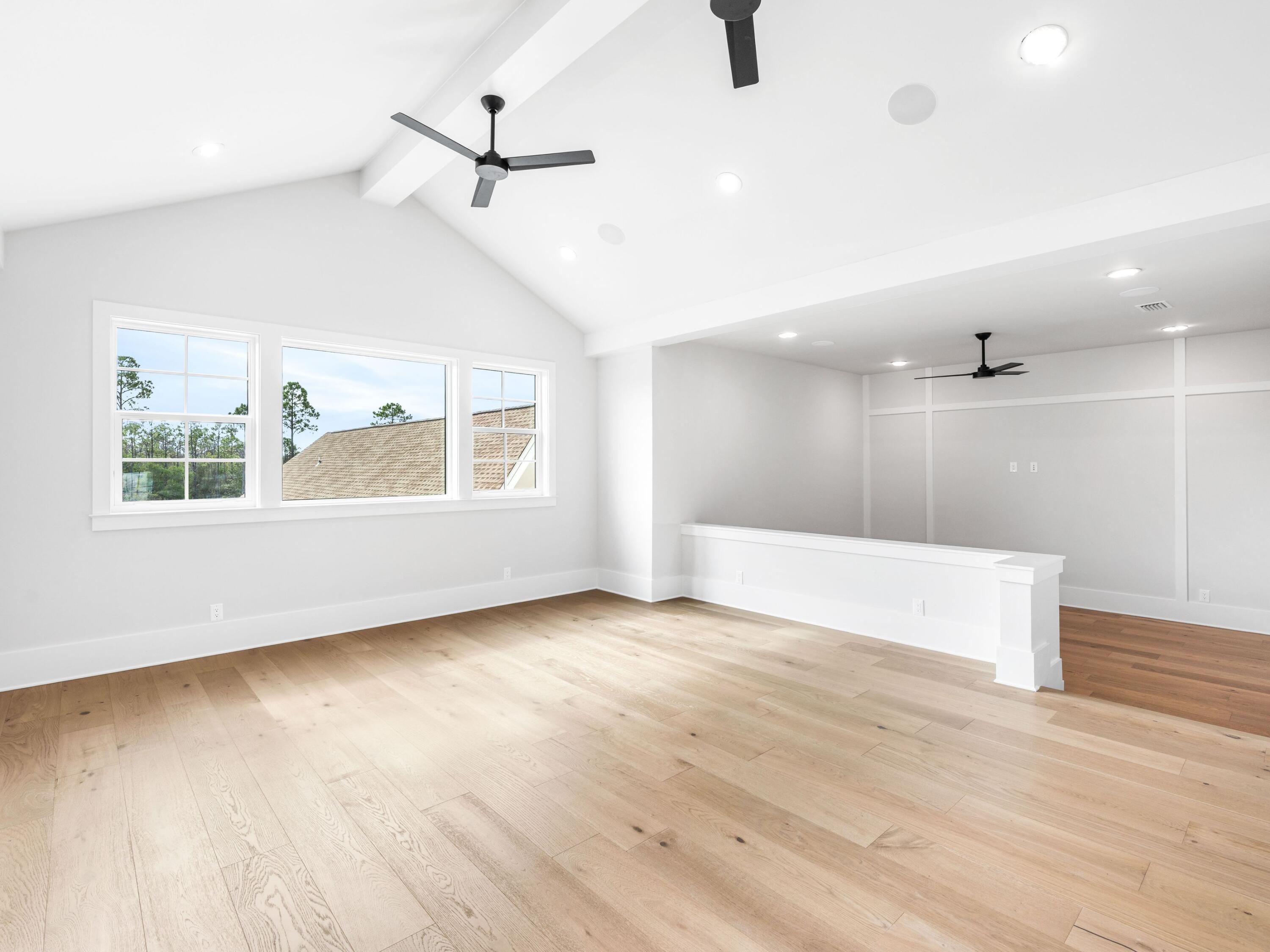 303 Golfridge Drive Watersound, FL 32461 - Photo 31 of 50 an empty room with wooden floor fan and windows
