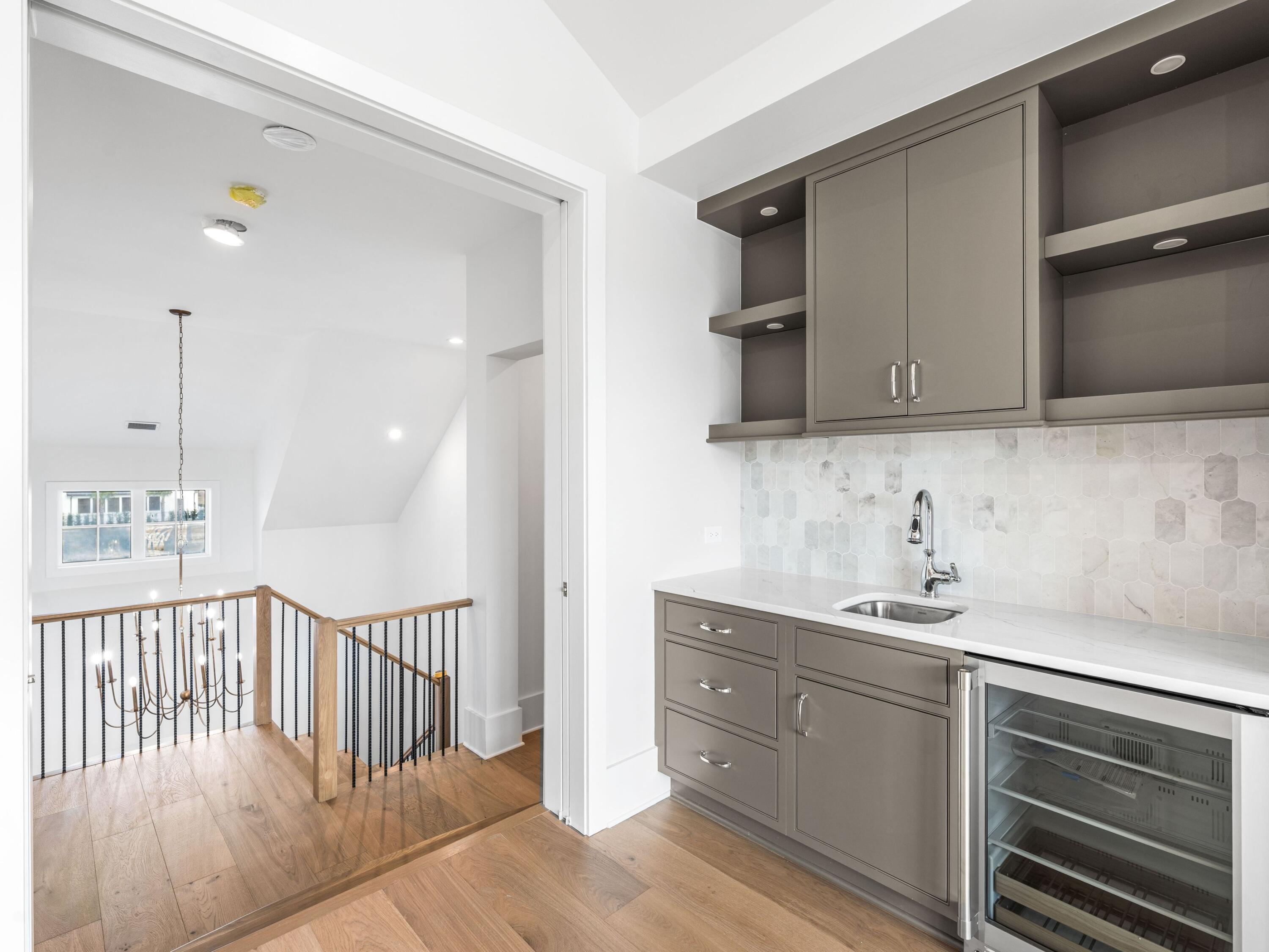 303 Golfridge Drive Watersound, FL 32461 - Photo 32 of 50 a kitchen with a sink and cabinets